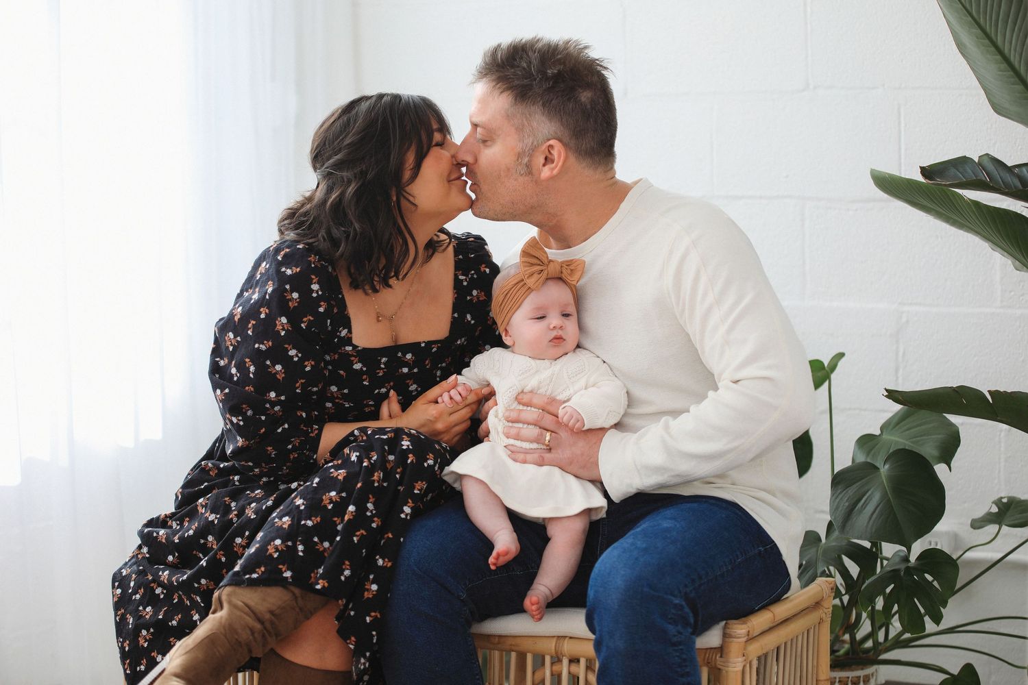 A family shares tender moments with their newborn baby in a series of candid photographs at home.