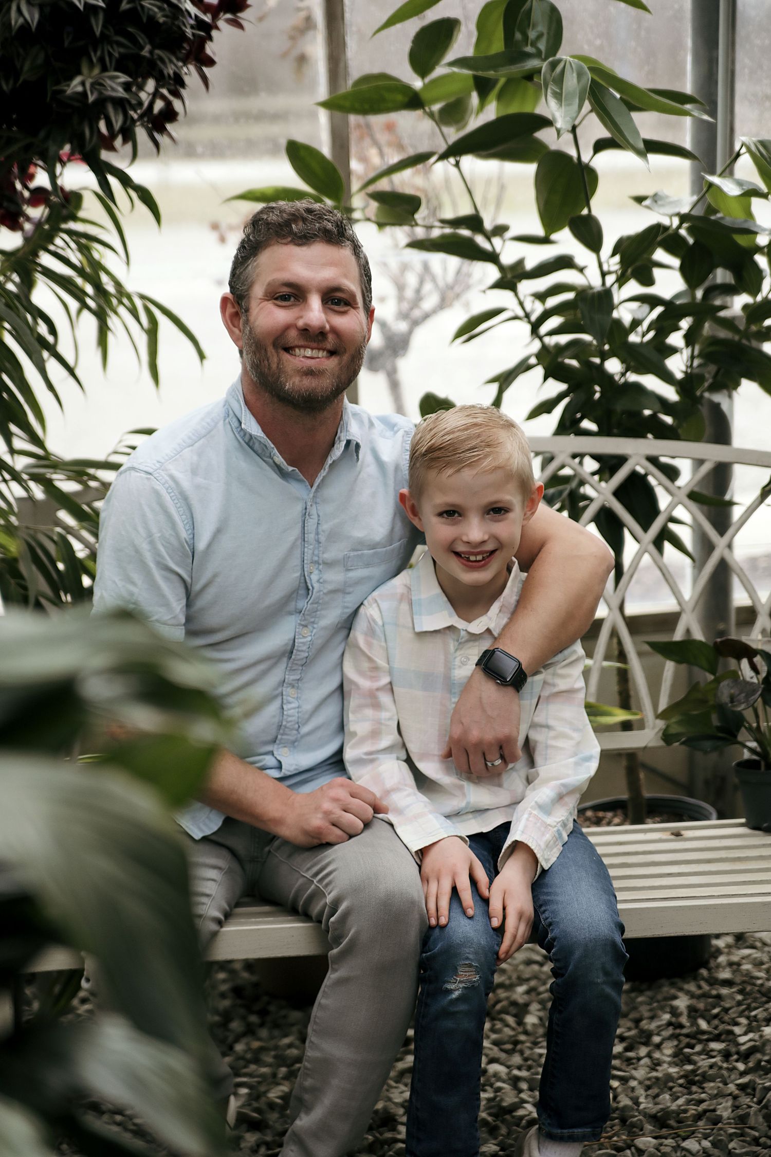 A heartwarming candid photo series showing joyful moments shared between an adult and child on a bench with plants nearby.
