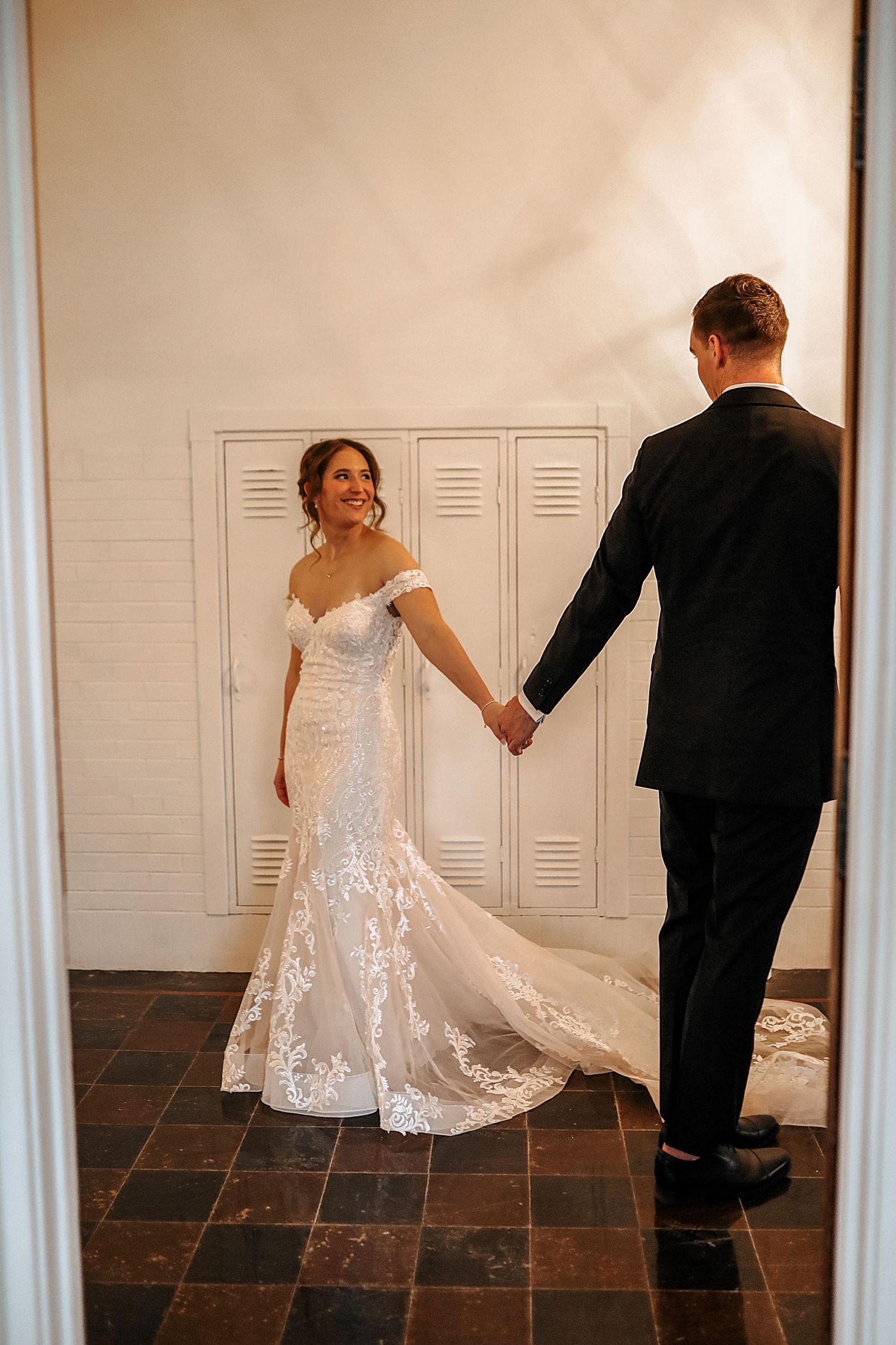 A sequence of three wedding photos showing a couple dancing and twirling in a room with white lockers and tile floor.