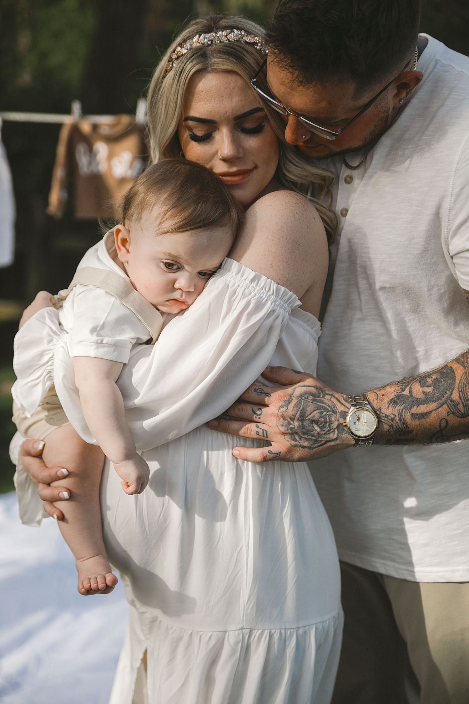 An intimate series of photos showing someone in a white dress being held and comforted in tender embraces.
