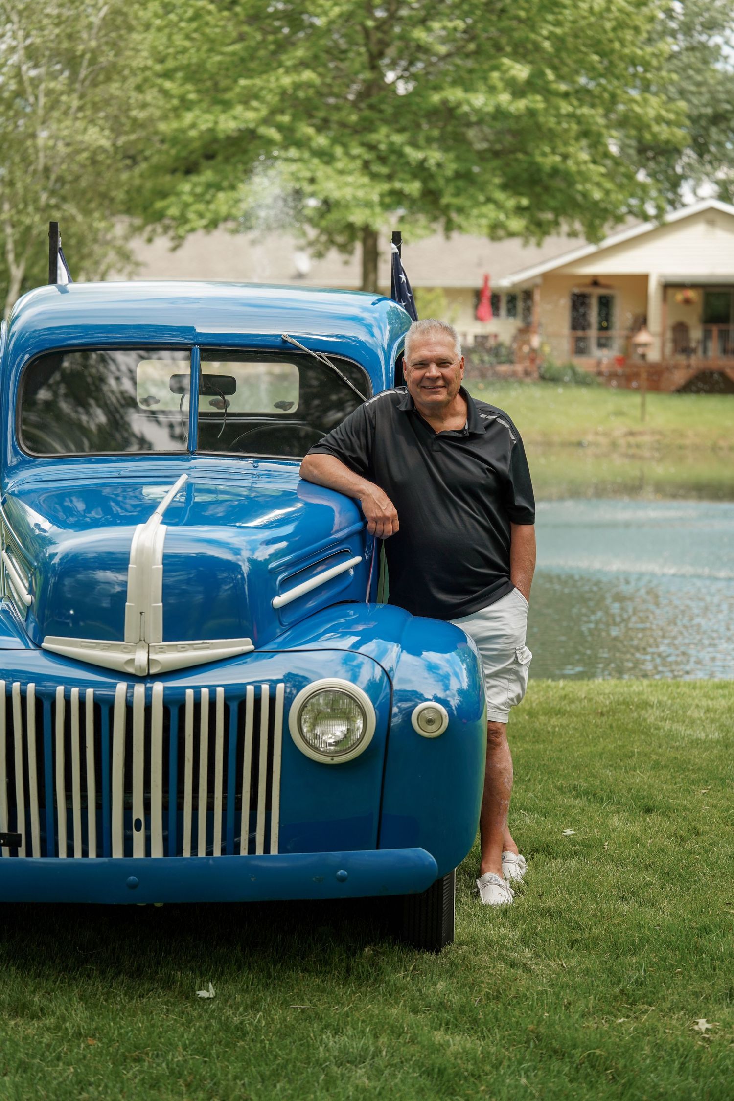 Close-up shots of a classic bright blue vintage car with chrome trim and grille details on grass.
