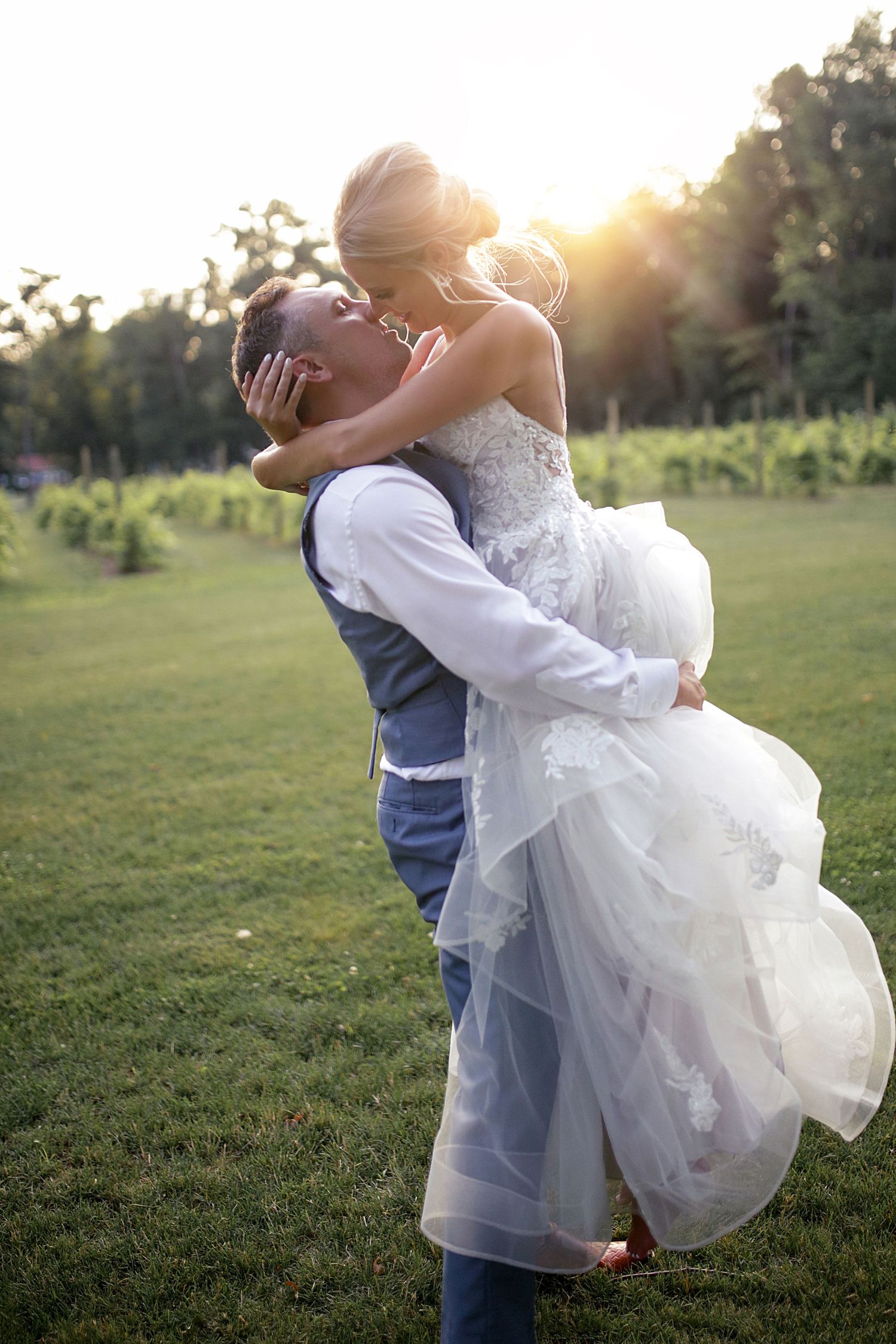 Joyful sunset wedding portrait with couple embracing in outdoor setting.