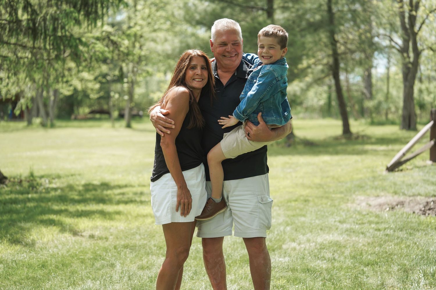 A series of outdoor family photoshoot scenes captured in a sunlit wooded park setting.