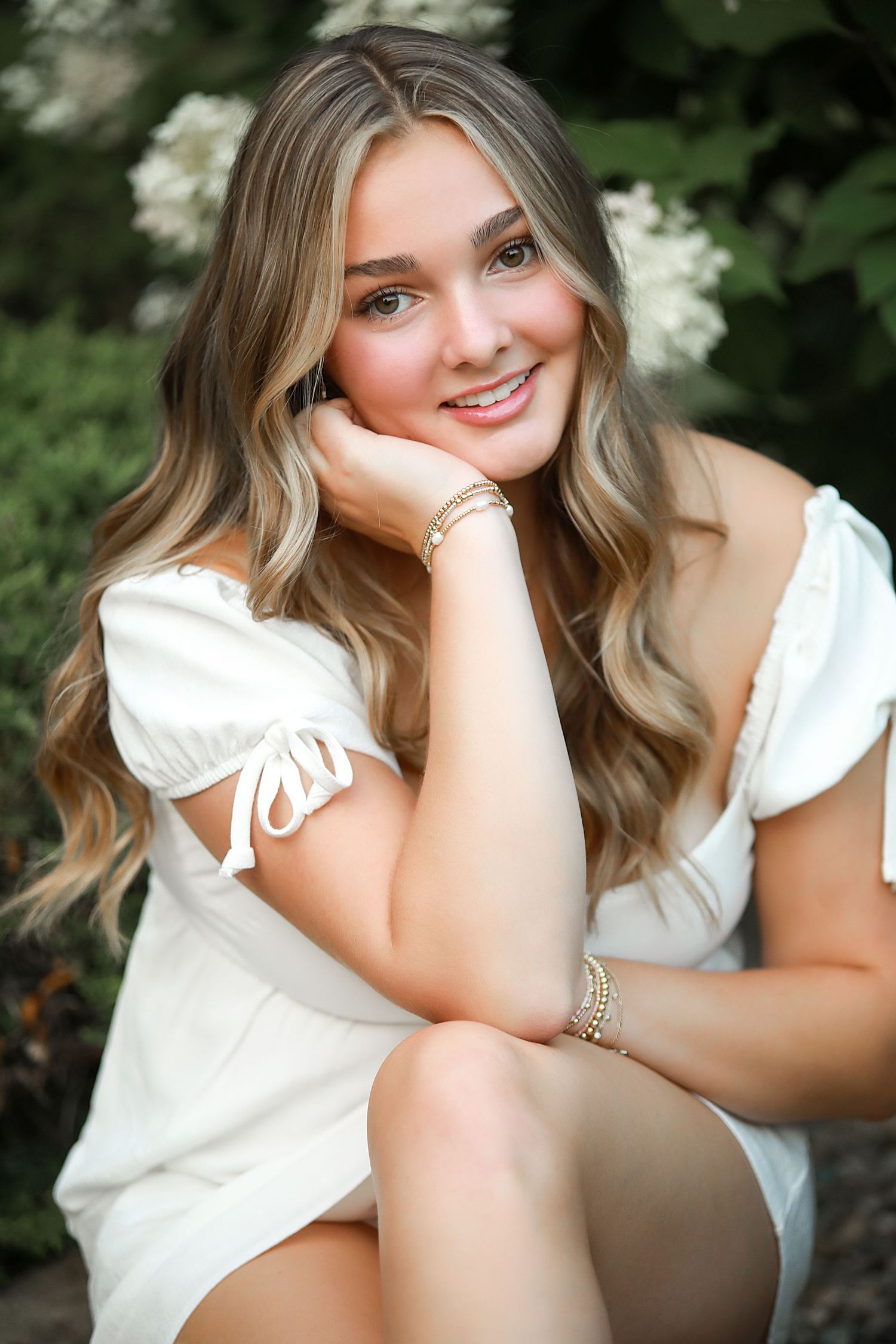 Senior Photography Chagrin Falls Ohio. Outdoor portrait session featuring white summer dress against lush garden backdrop.