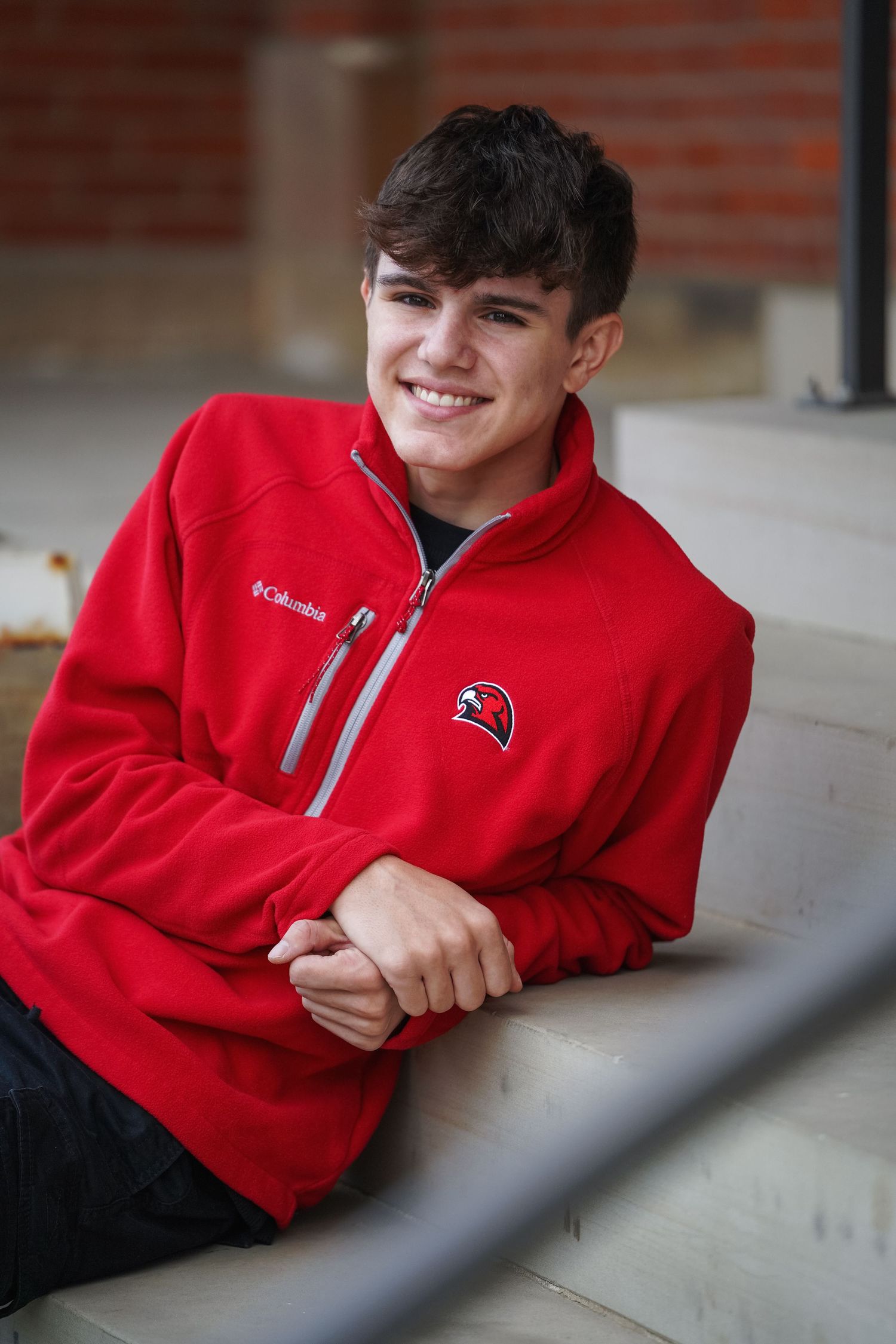Close-up photo series of person in red Ball State Cardinals sweatshirt smiling while sitting on concrete steps.