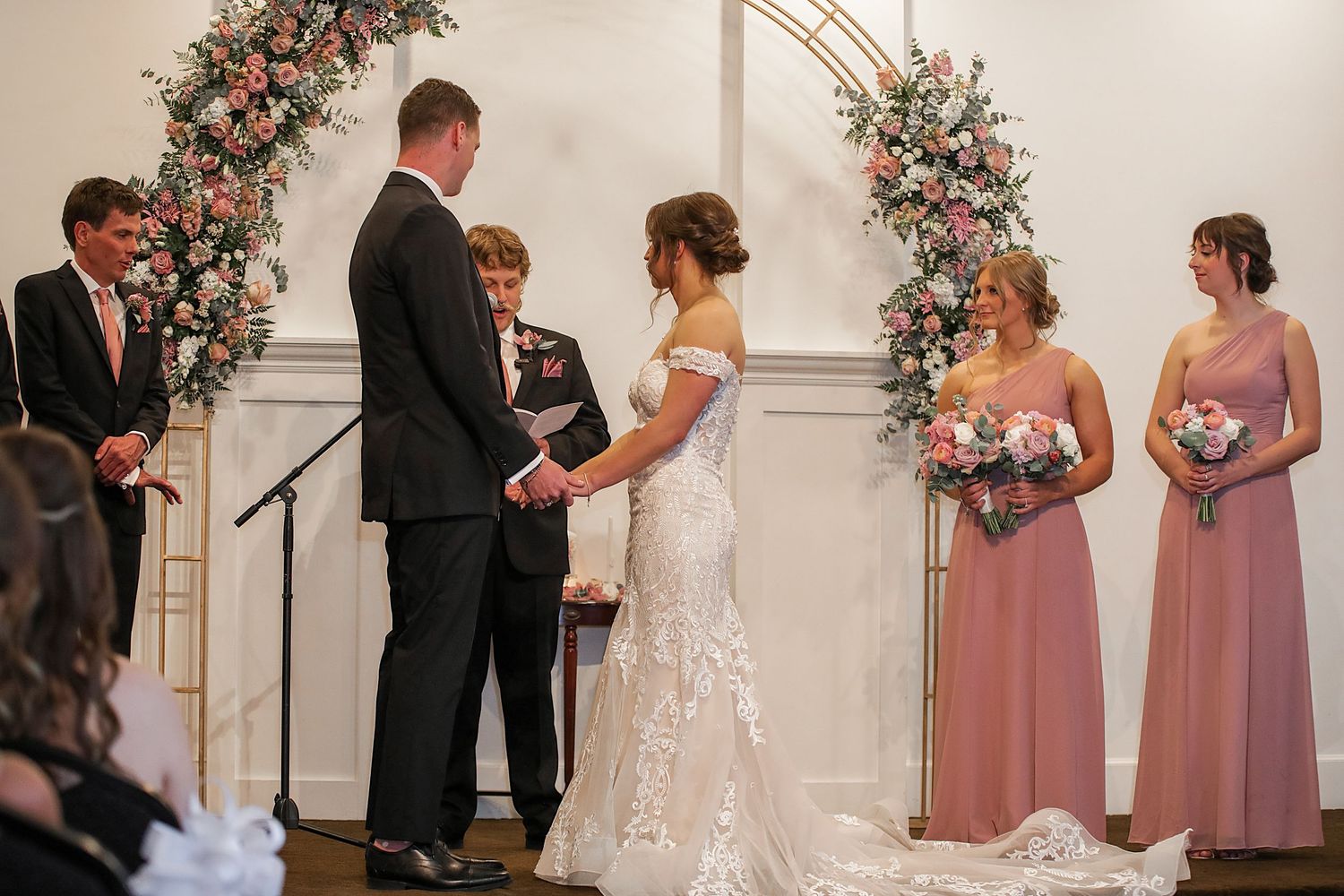 A wedding ceremony sequence shows intimate moments between the couple and wedding party in a light-filled venue with floral decor.