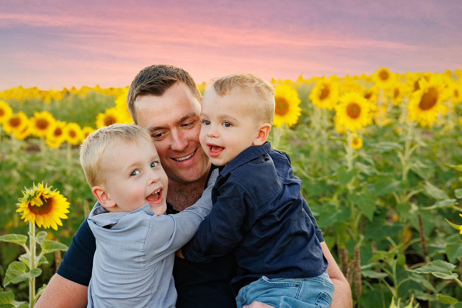 Joyful family moment captured in a vibrant sunflower field during a colorful sunset.
