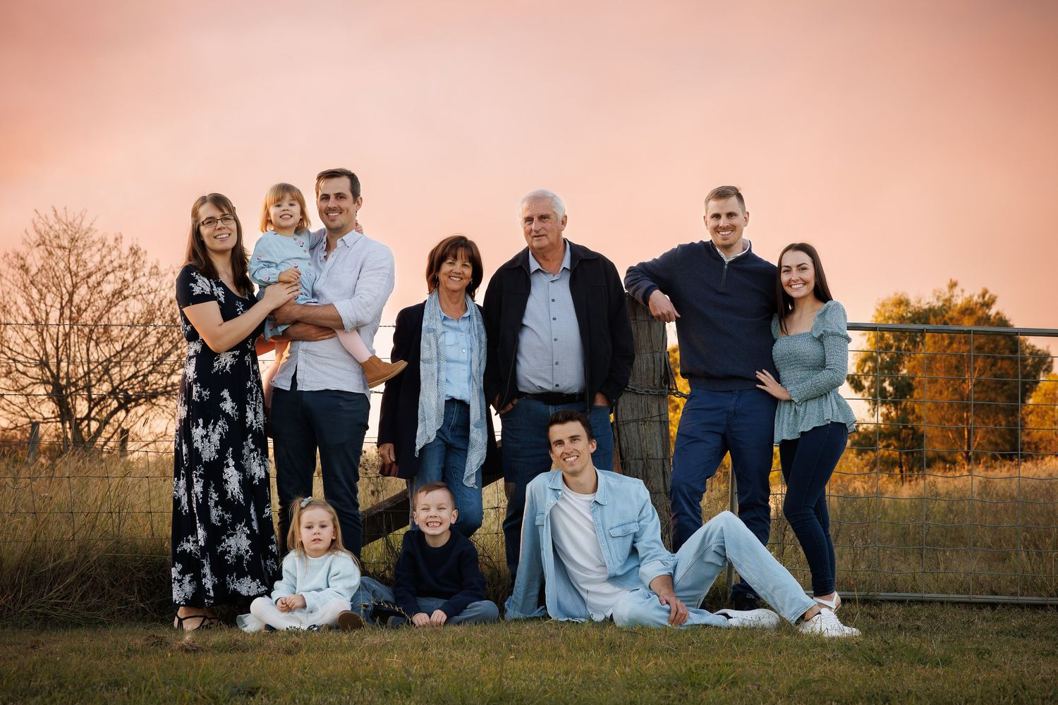 A series of outdoor family portraits at sunset showing multiple people sitting and standing together in casual attire.