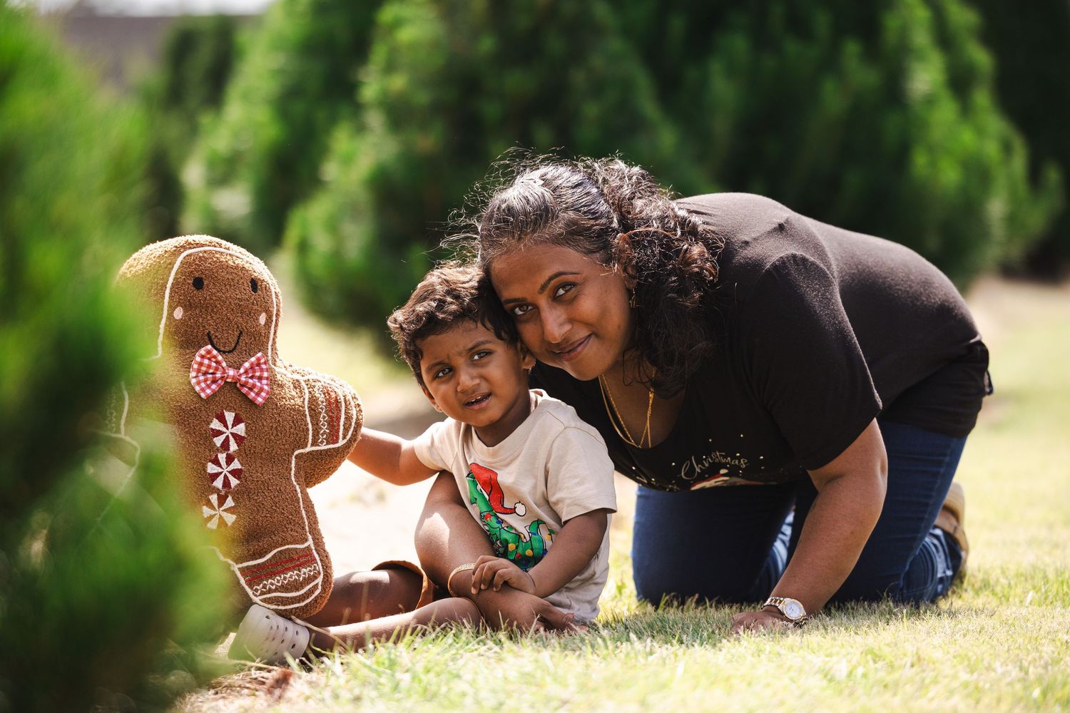 Group of children playing and interacting together outdoors in a sunny grassy field.