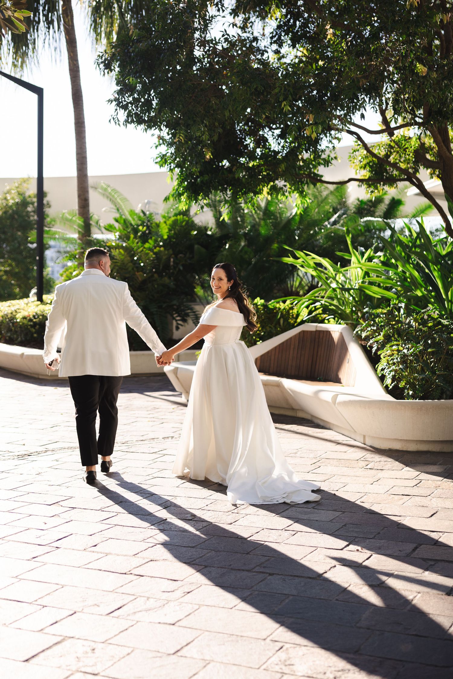 A sequence showing a dancing couple in wedding attire spinning on an outdoor terrace surrounded by lush greenery.