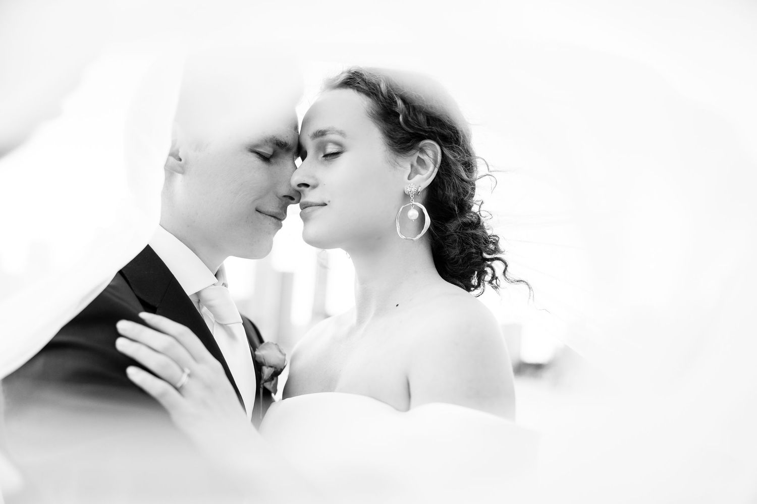 A romantic black and white wedding photo collage showing intimate moments between the newlyweds.