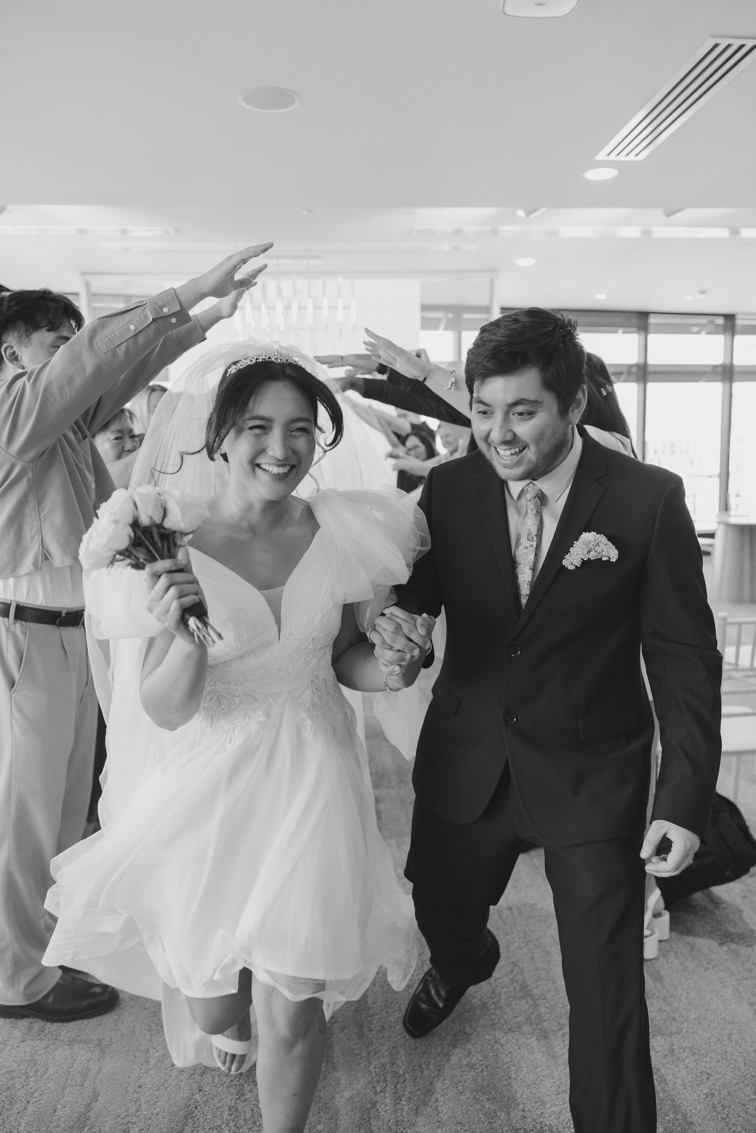 A sequence of black and white photos showing a couple dancing and twirling in a wedding dress and suit at their reception.