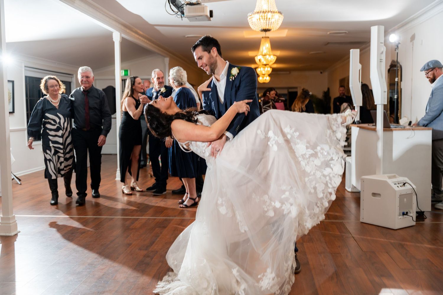 A sequence of wedding reception moments showing dancing and celebration in an elegant indoor venue with wooden floors.
