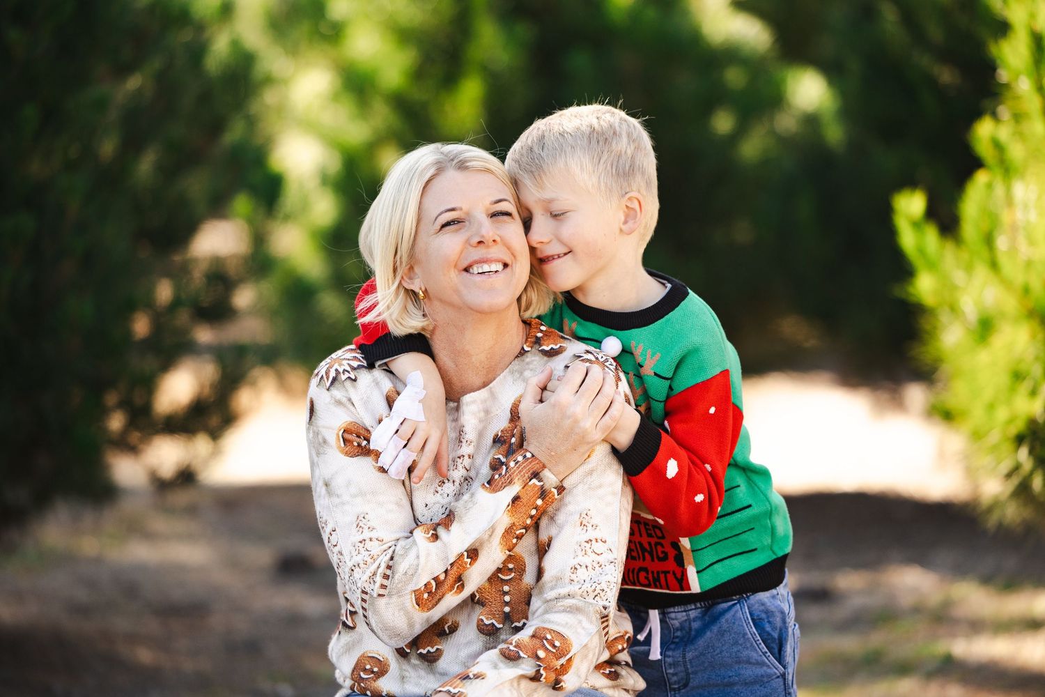 A heartwarming outdoor photoshoot showing tender family moments in a sunlit garden setting.