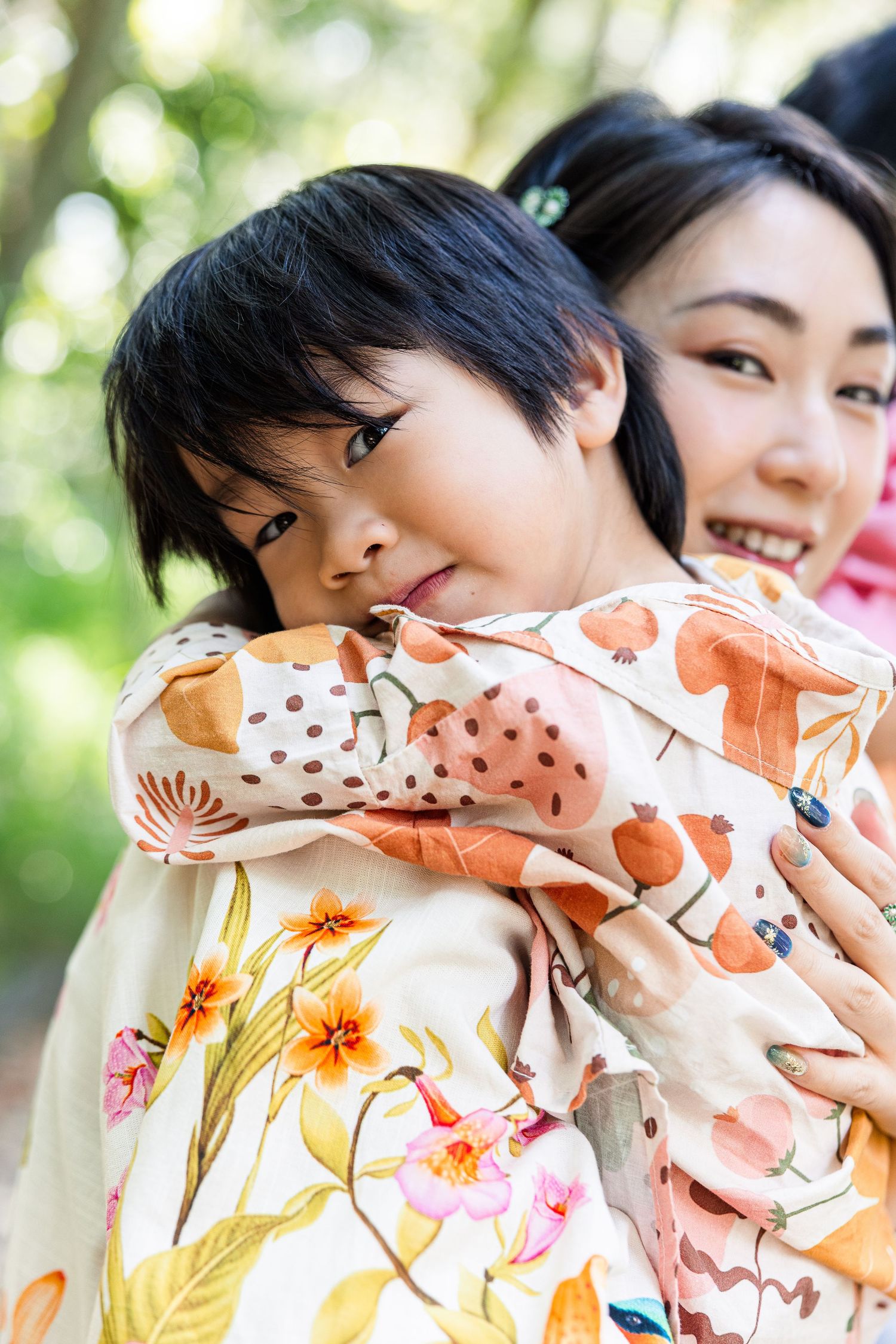Floral patterned fabric or textile design with soft peach and orange tones against a light background.
