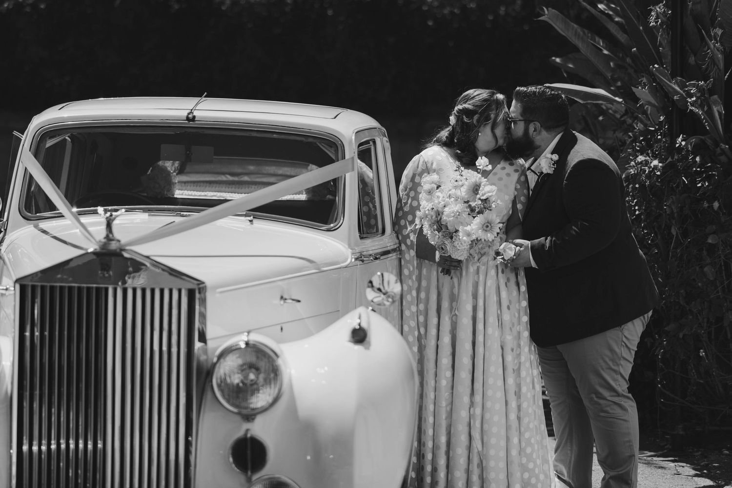 A collection of vintage wedding photographs featuring classic cars and elegant bridal scenes in black and white.