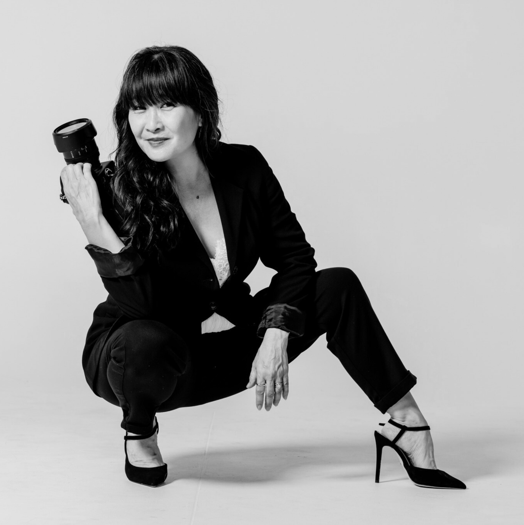 A series of dynamic fashion poses in black and white showing a figure in a black blazer and heels against a white backdrop.