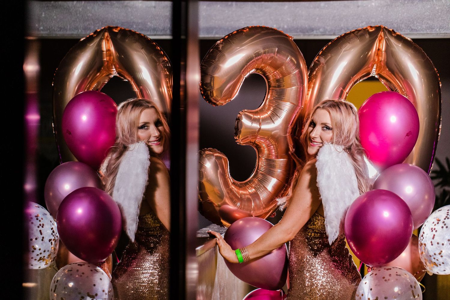 Birthday party celebration with rose gold number 3 balloon and pink and silver decorative balloons.
