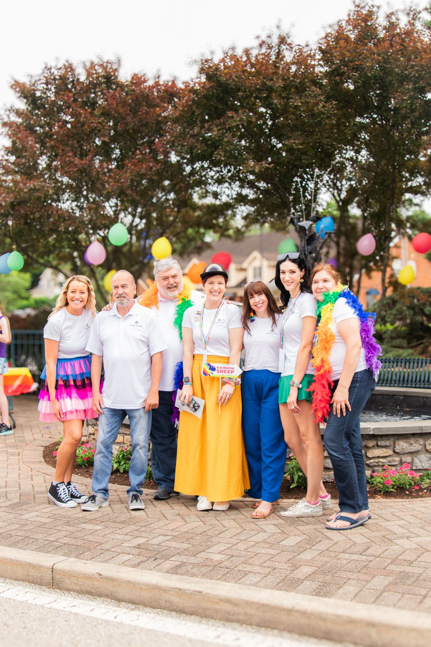 Group of people smiling at outdoor park pride event for community