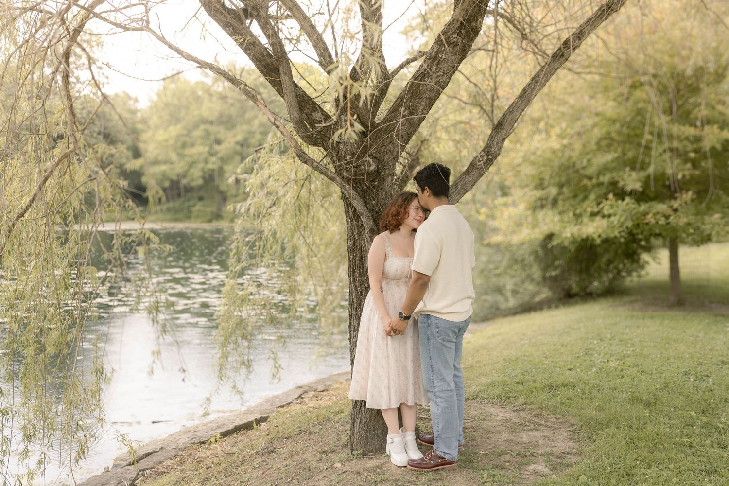 Couple standing together in front of pond at the cemetery