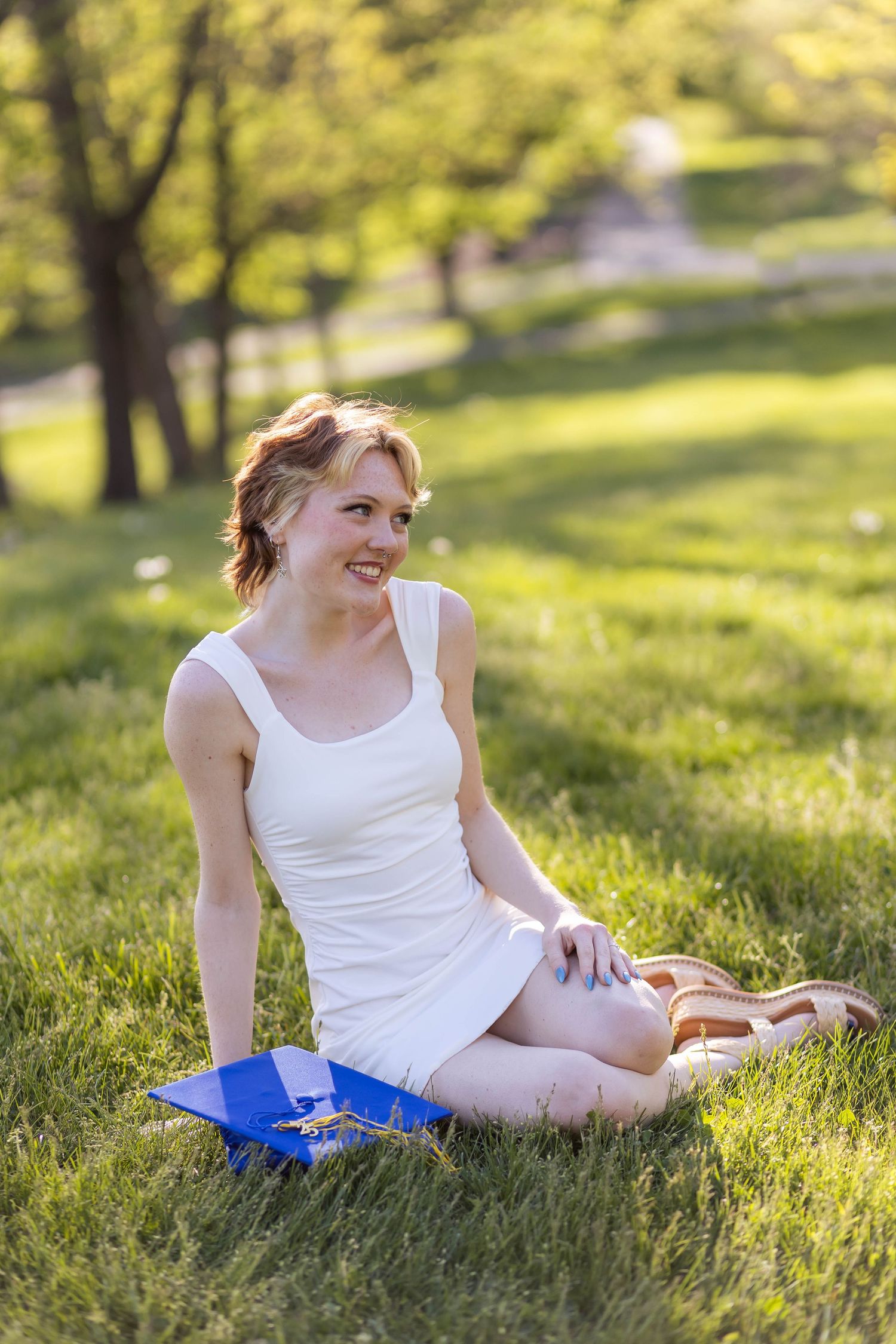 Senior portrait in park with spring greenery and soft natural light