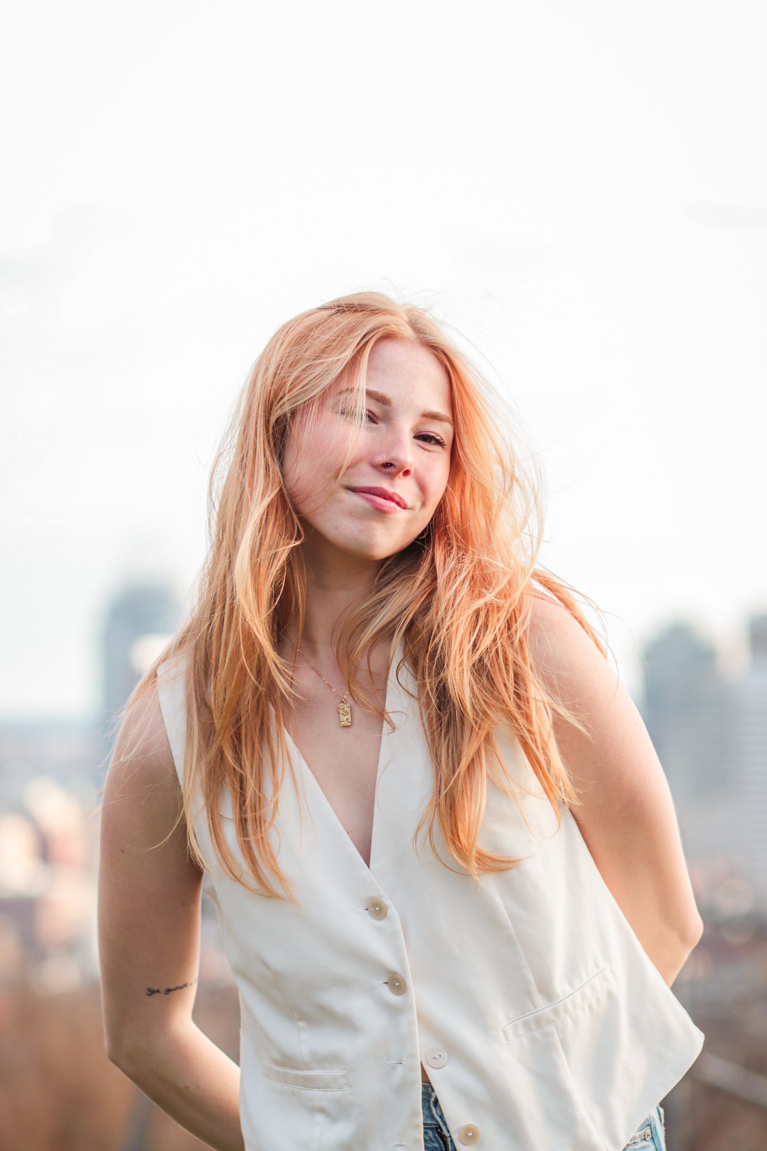Outdoor branding headshot of creative professional with blurred city background