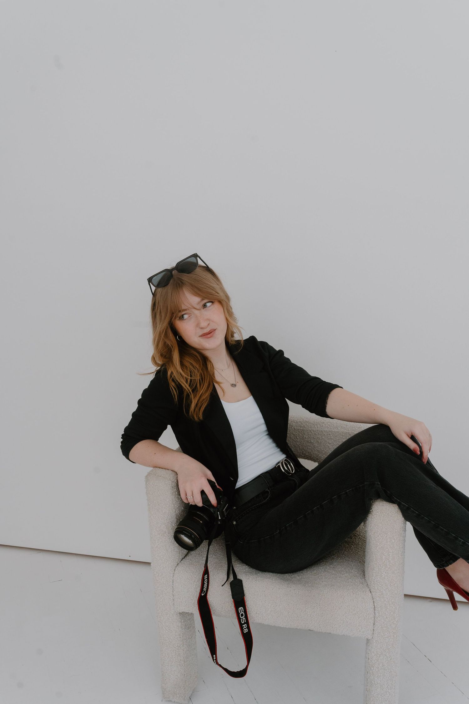 Studio headshot of photographer in business outfit for brand photos