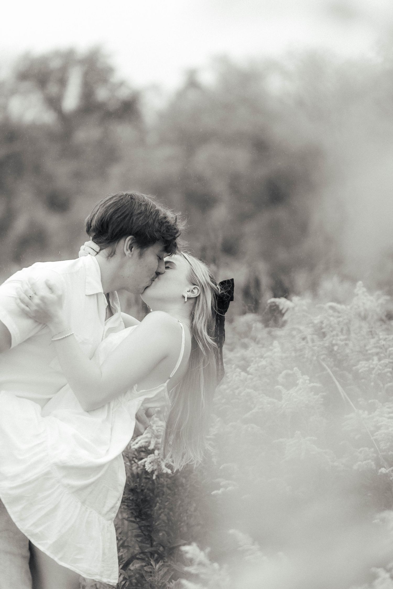 Romantic couple portrait in park landscape in black and white