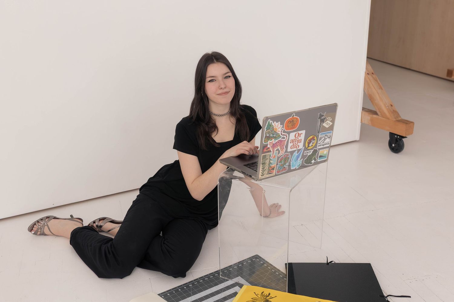 Woman sitting with computer in studio