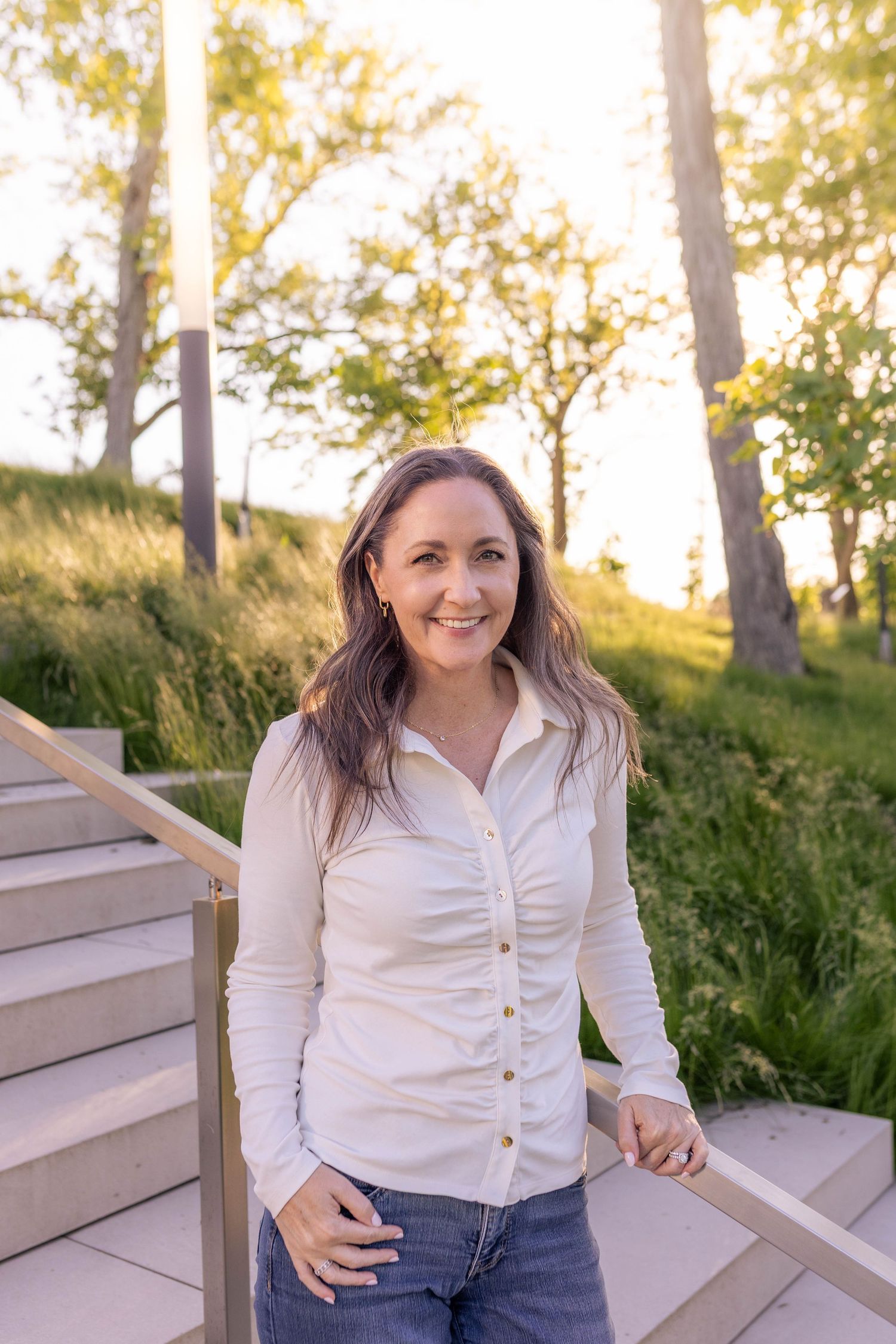 Modern woman business headshot in park-setting during golden hour