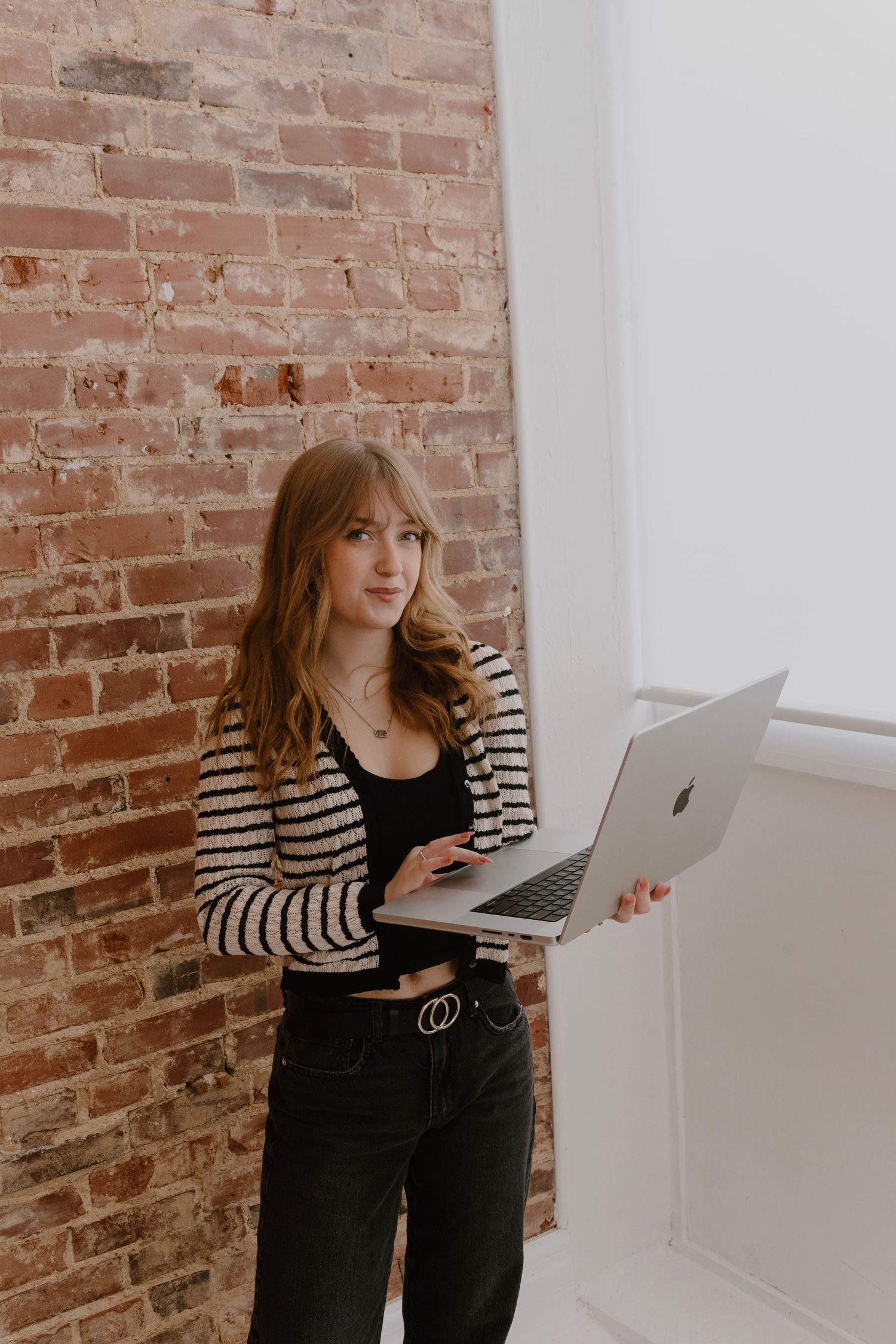 Clean studio branding portrait with soft lighting and brick backdrop