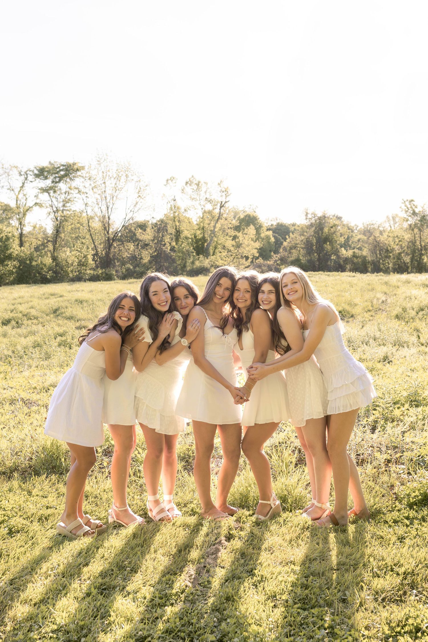 Group of senior girls standing in field laughing together