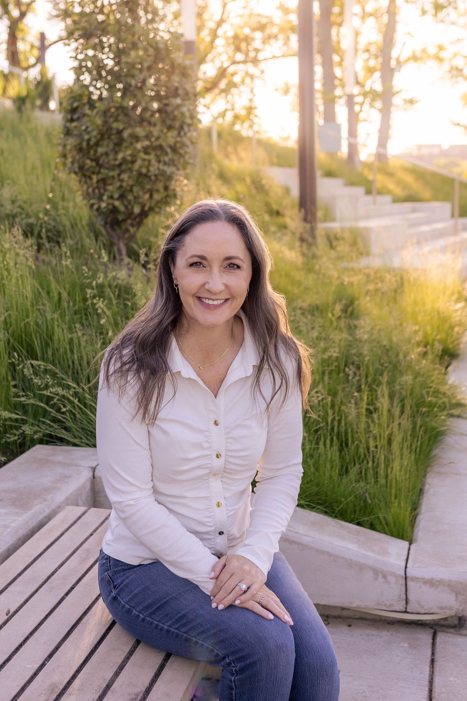Modern woman business headshot in park-setting during golden hour