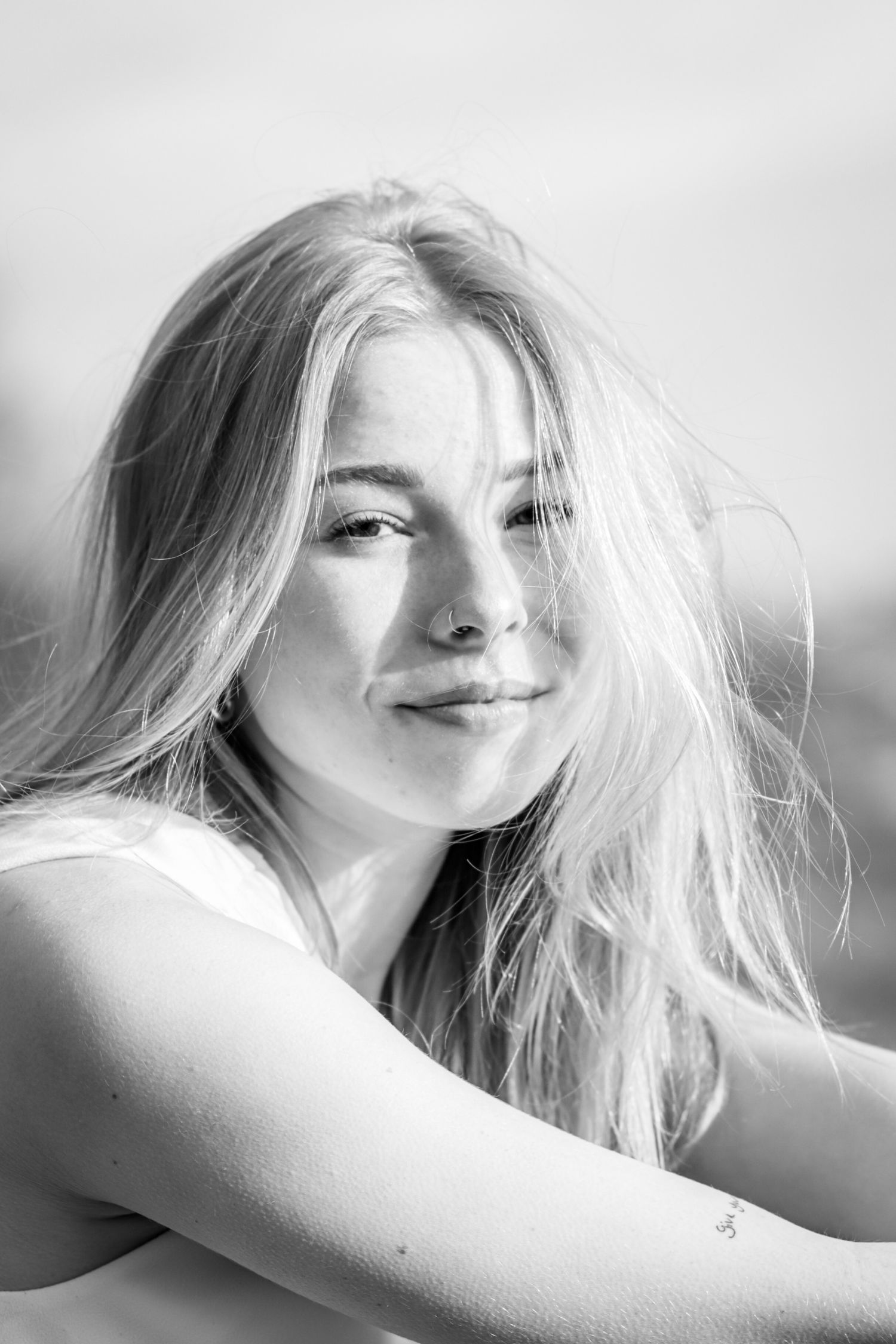 Black and white close up portrait of teen girl smiling softly