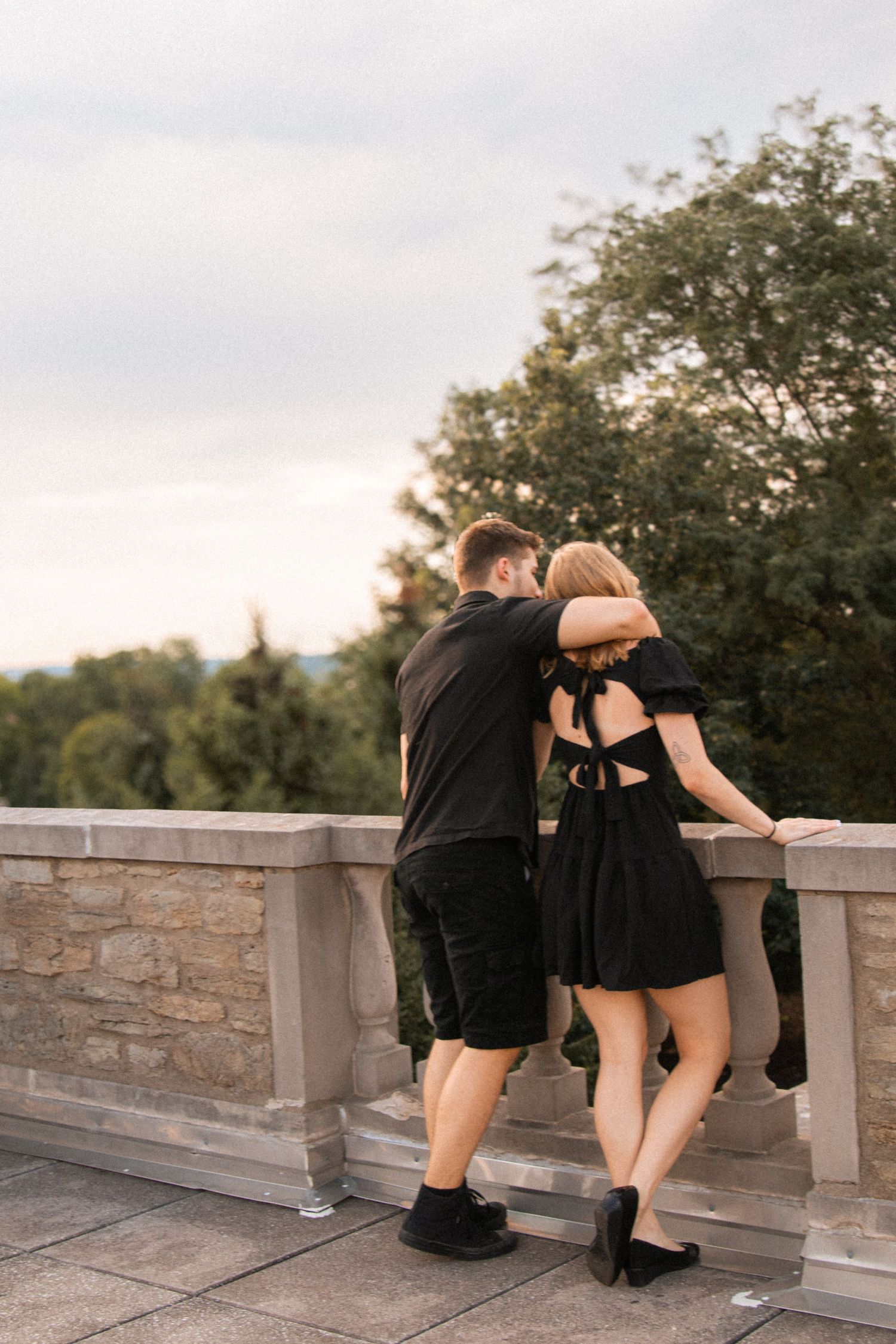 Candid couple photo standing together while the sun sets