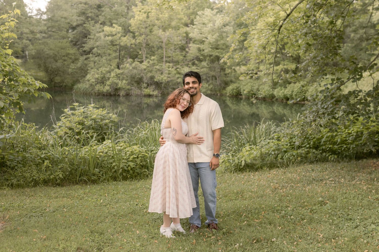 Couple standing together in front of pond at the cemetery