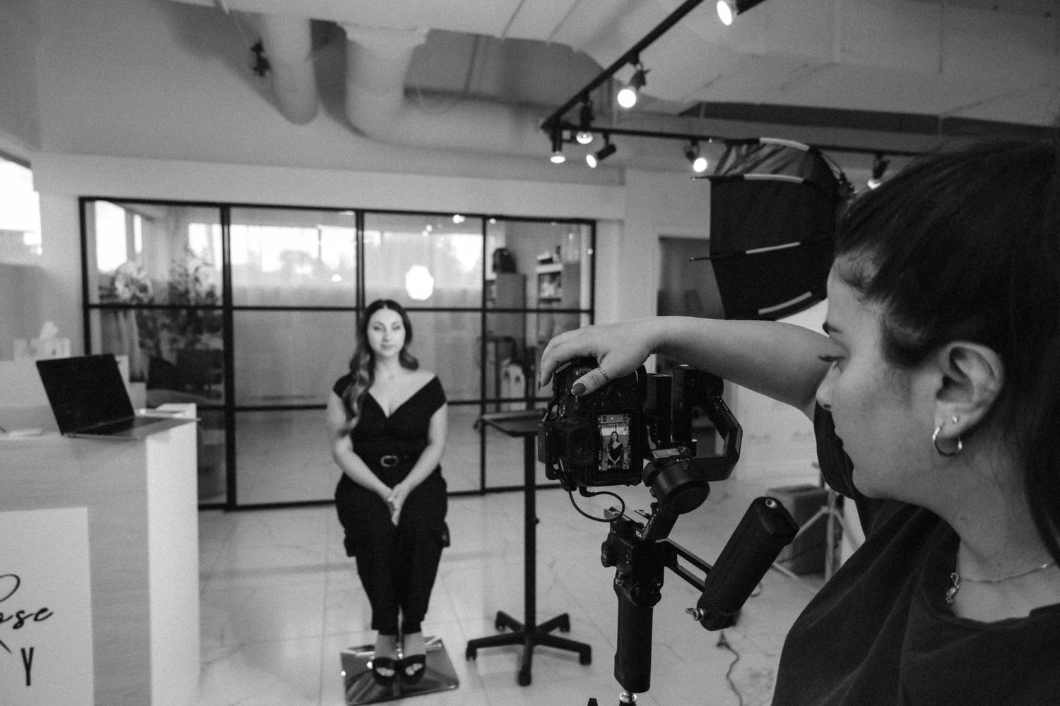 A series of black and white photos showing hands holding different types of microphones in recording studio settings.