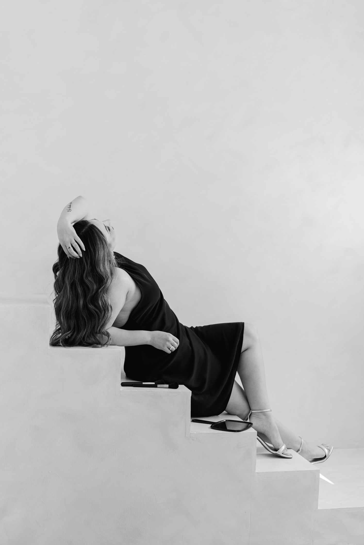 Artistic black and white photo series showing person in reclining poses.