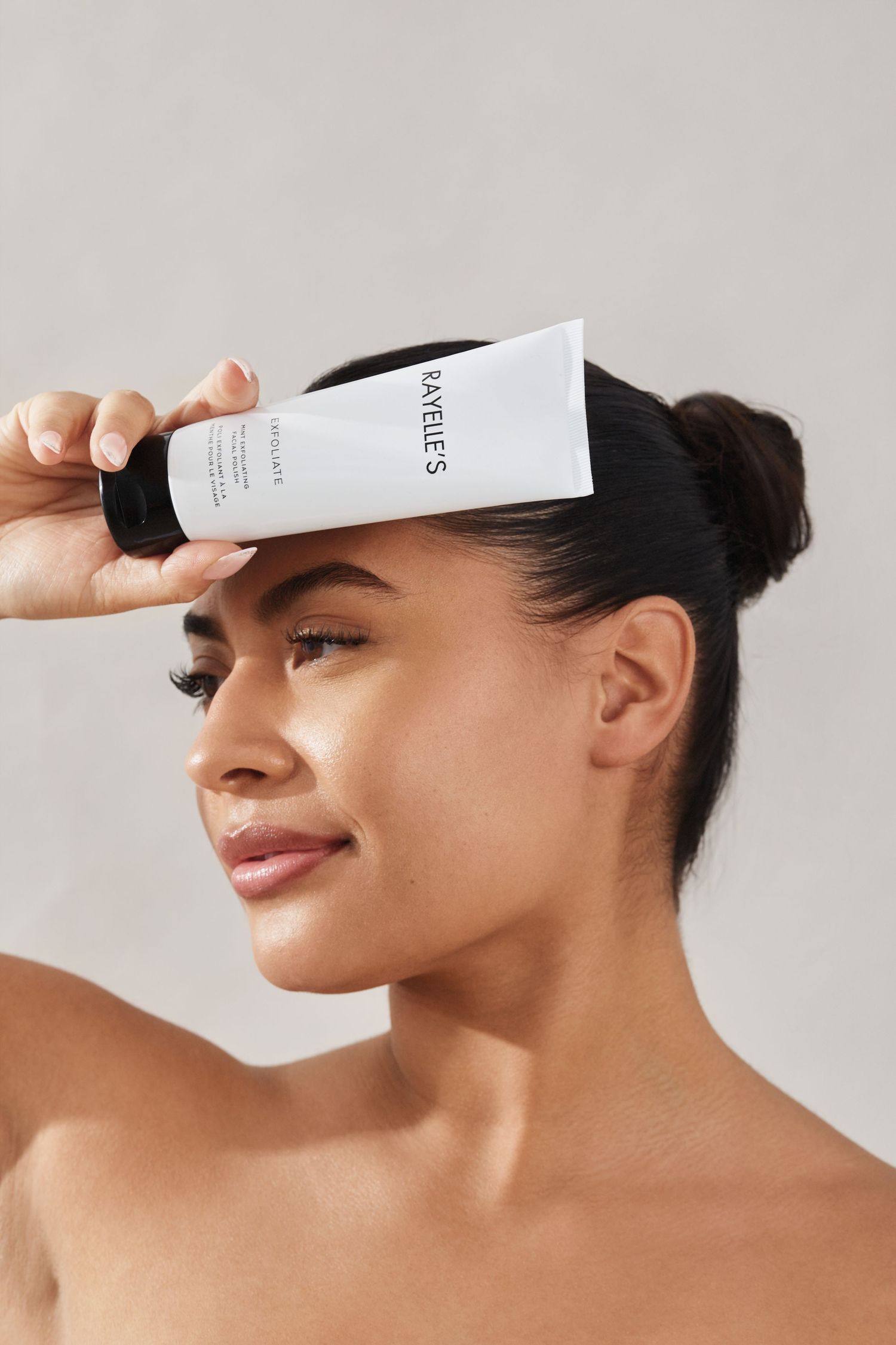 A series of skincare product application steps shown on a person's forehead against a white background.