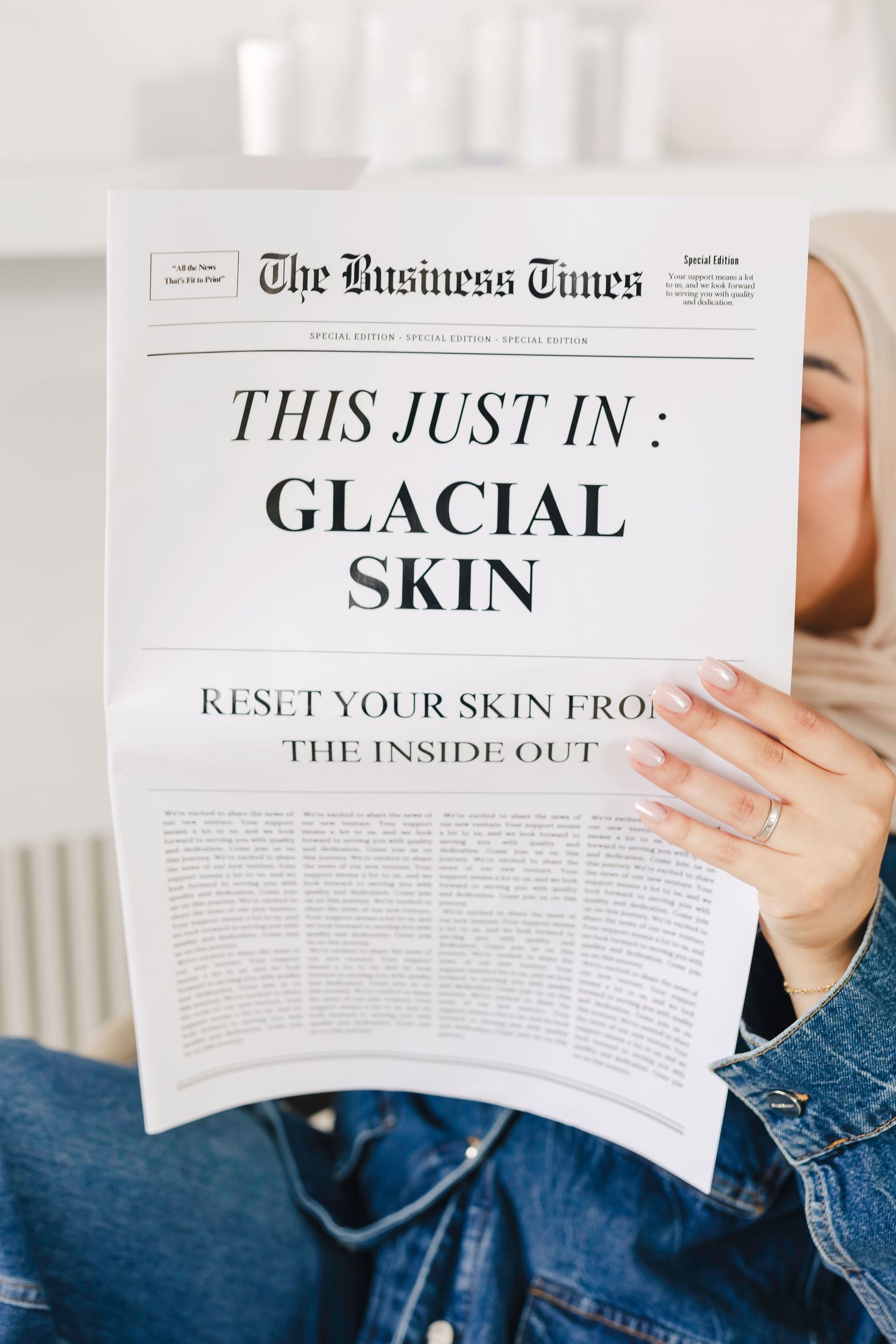Someone holding a newspaper with 'The Business Times' header and headline reading 'Glacial Skin' about skincare.