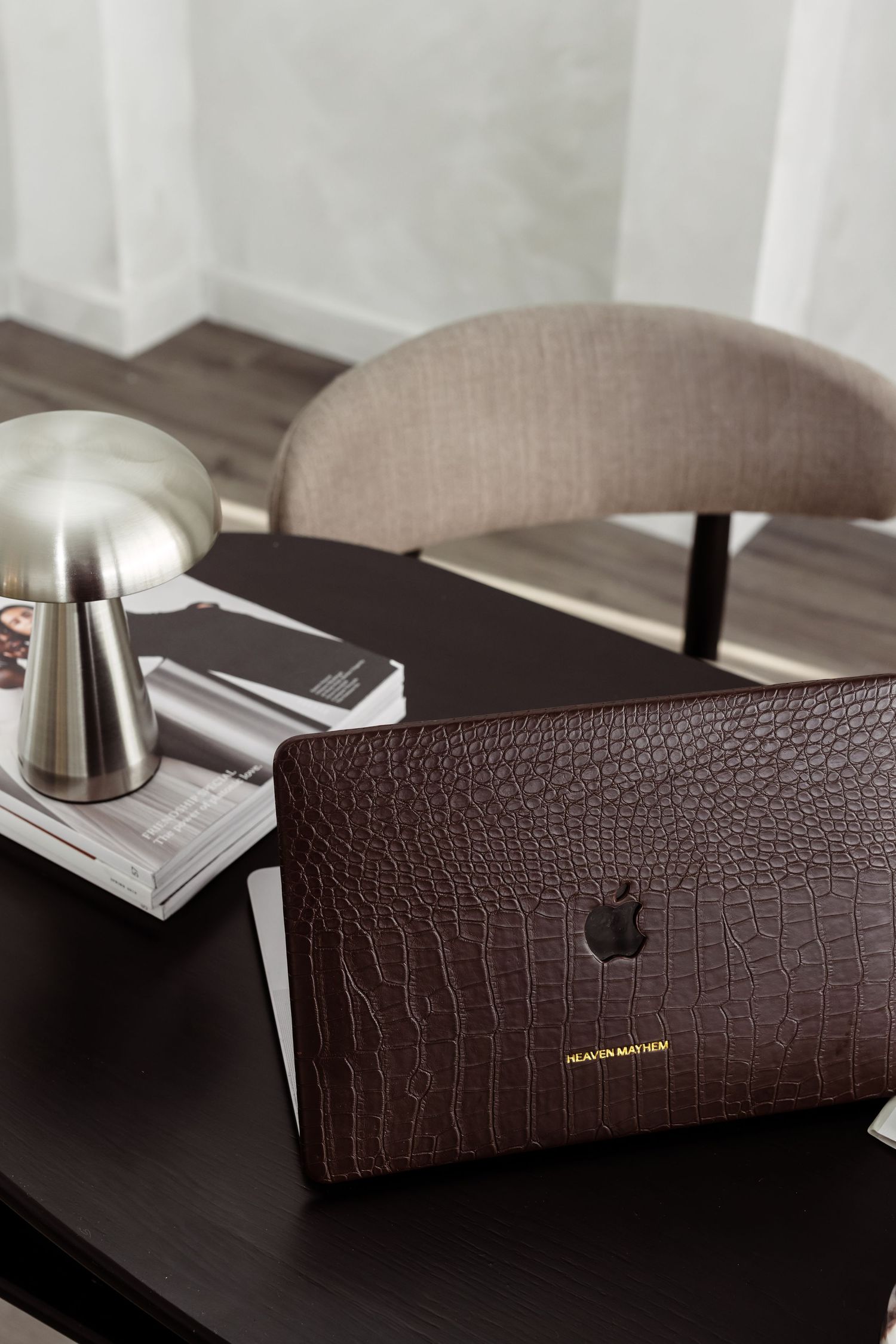 Brown leather wallet with textured crocodile pattern shown from multiple angles on a dark surface.