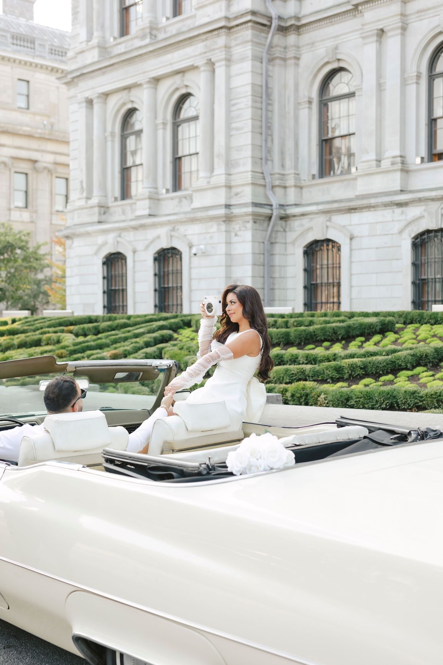 A sequence of photos showing someone in a white dress reclining on a stone bench outside an ornate historic building.