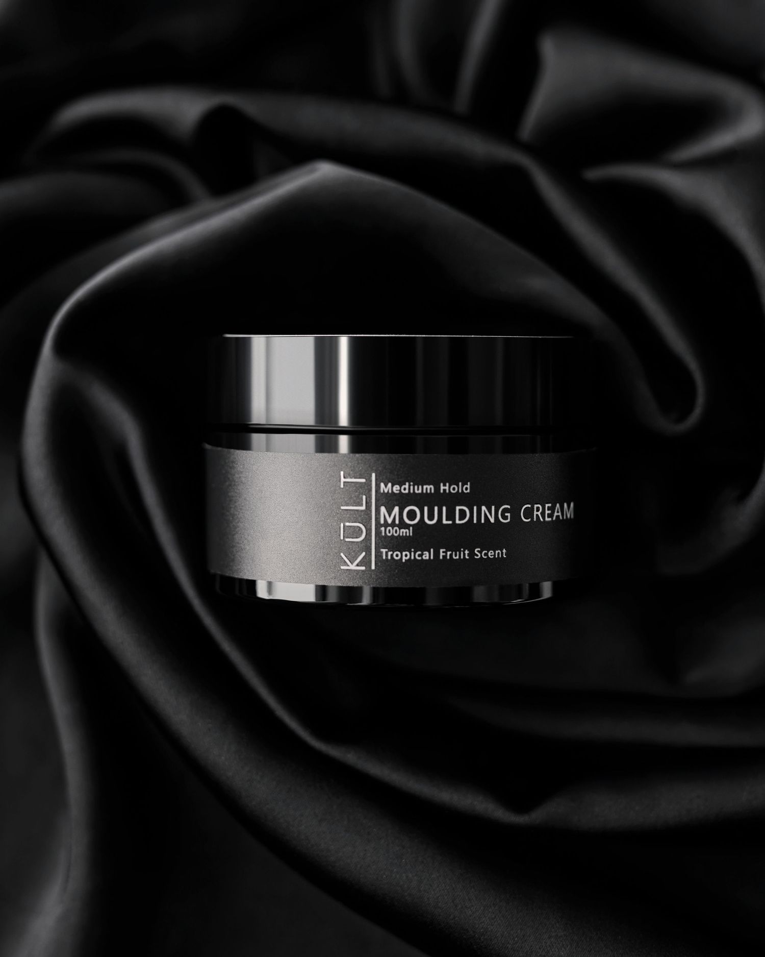 Sleek black cosmetic containers with moulding cream text on dark background with rose petal texture.