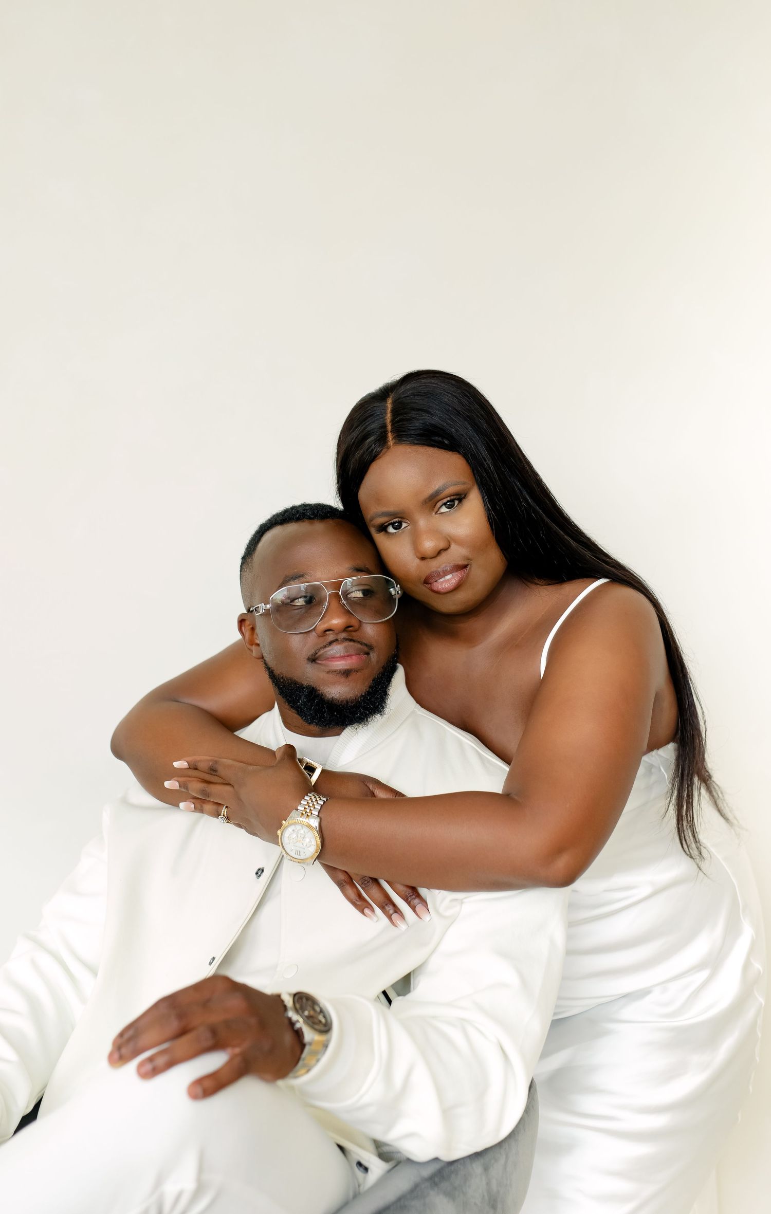 A couple wearing white outfits poses together in a romantic photo collage against a light background.