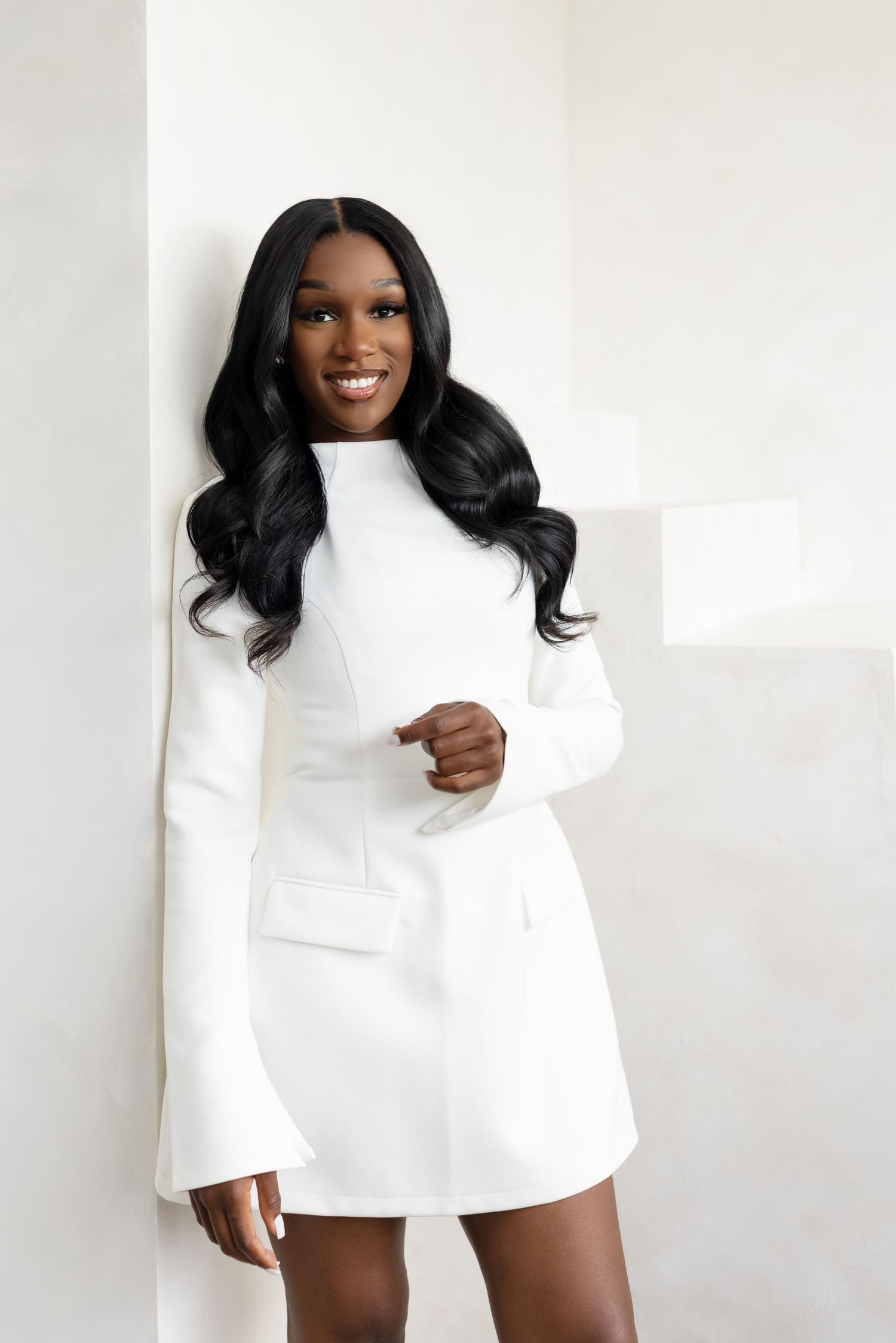 A collage of fashion poses wearing an elegant white long-sleeved mini dress against a light background.