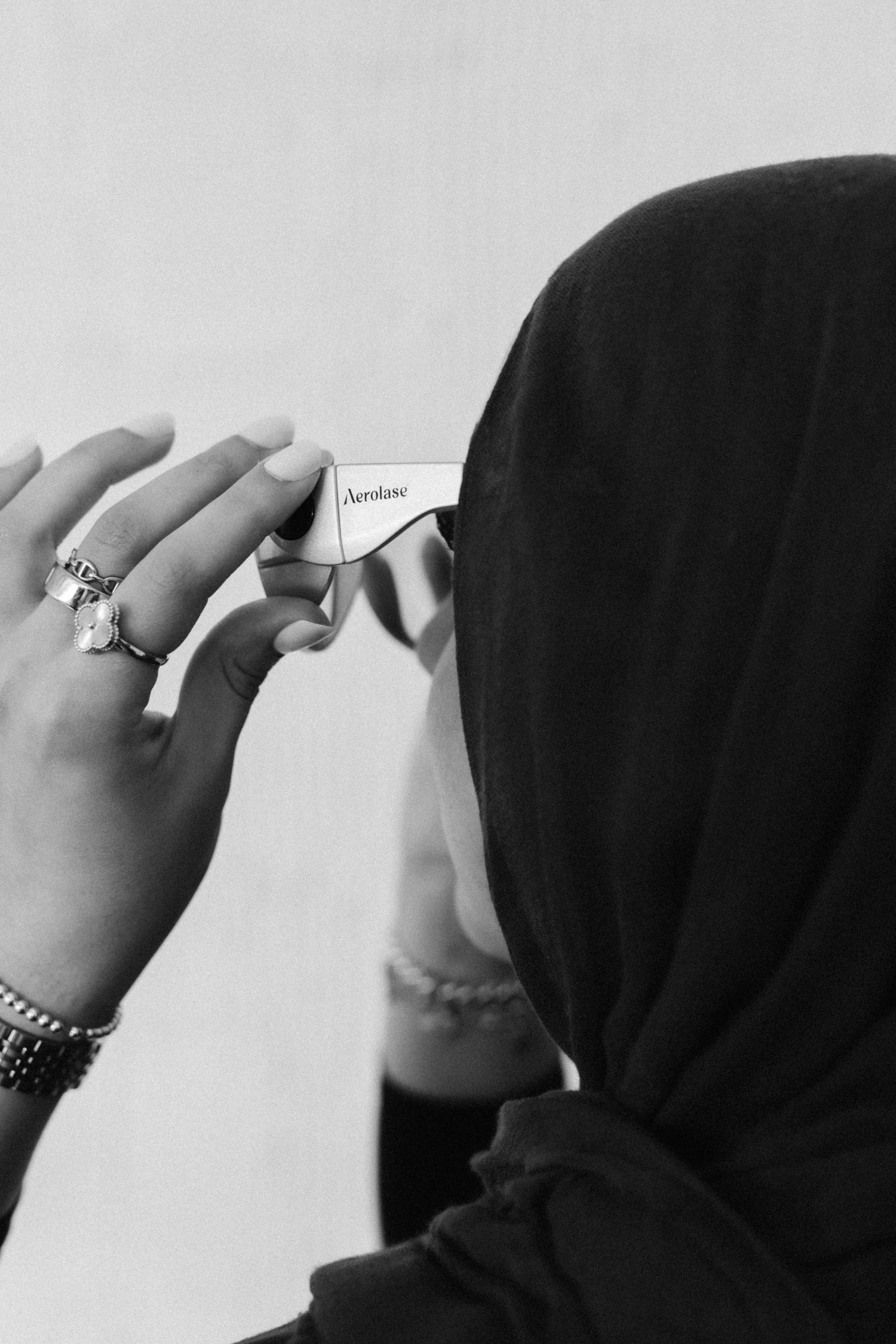 Four black and white close-up photos showing hands with rings against a plain background.