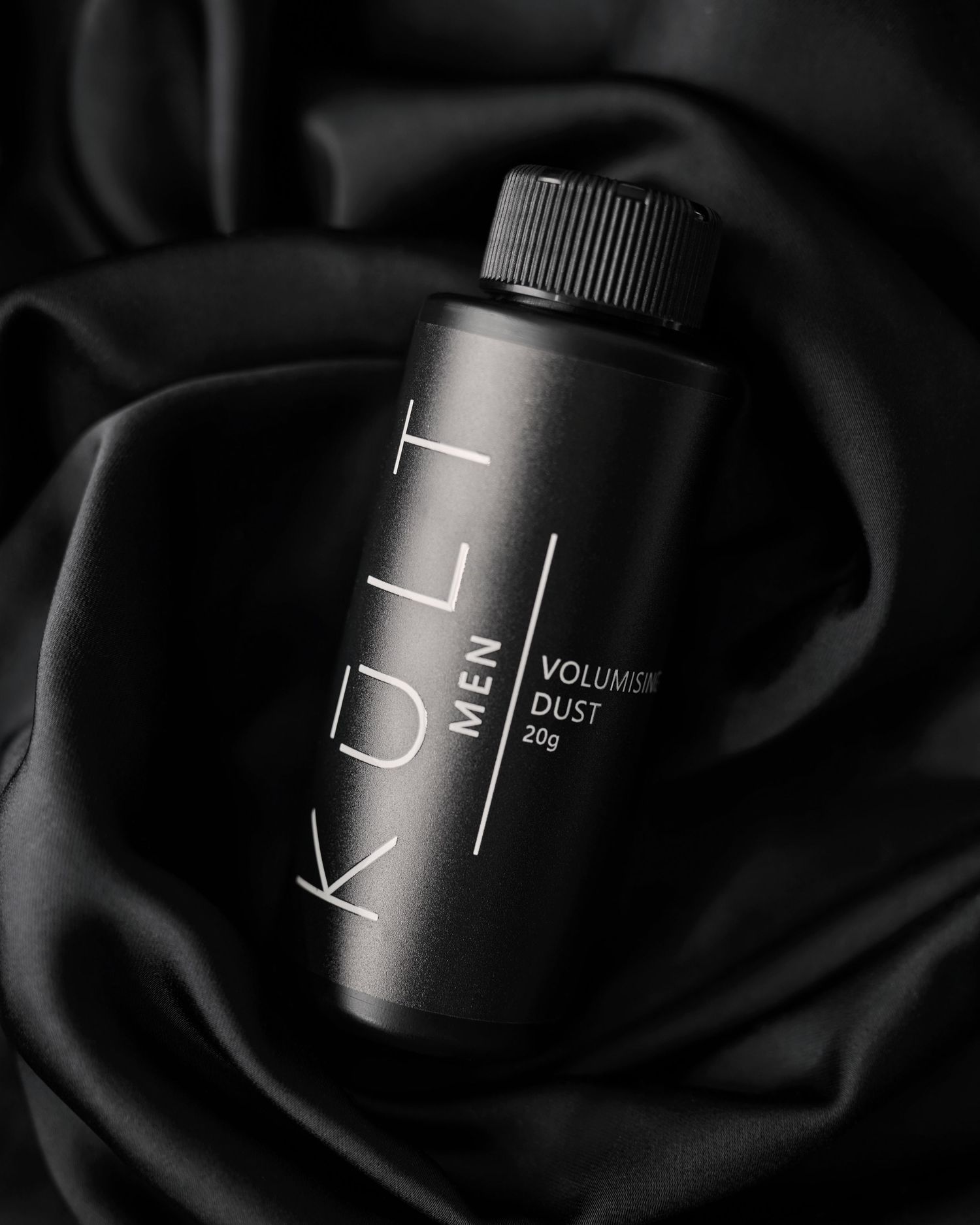 Close-up black and white photo of camera lens focusing rings showing detailed mechanical controls.