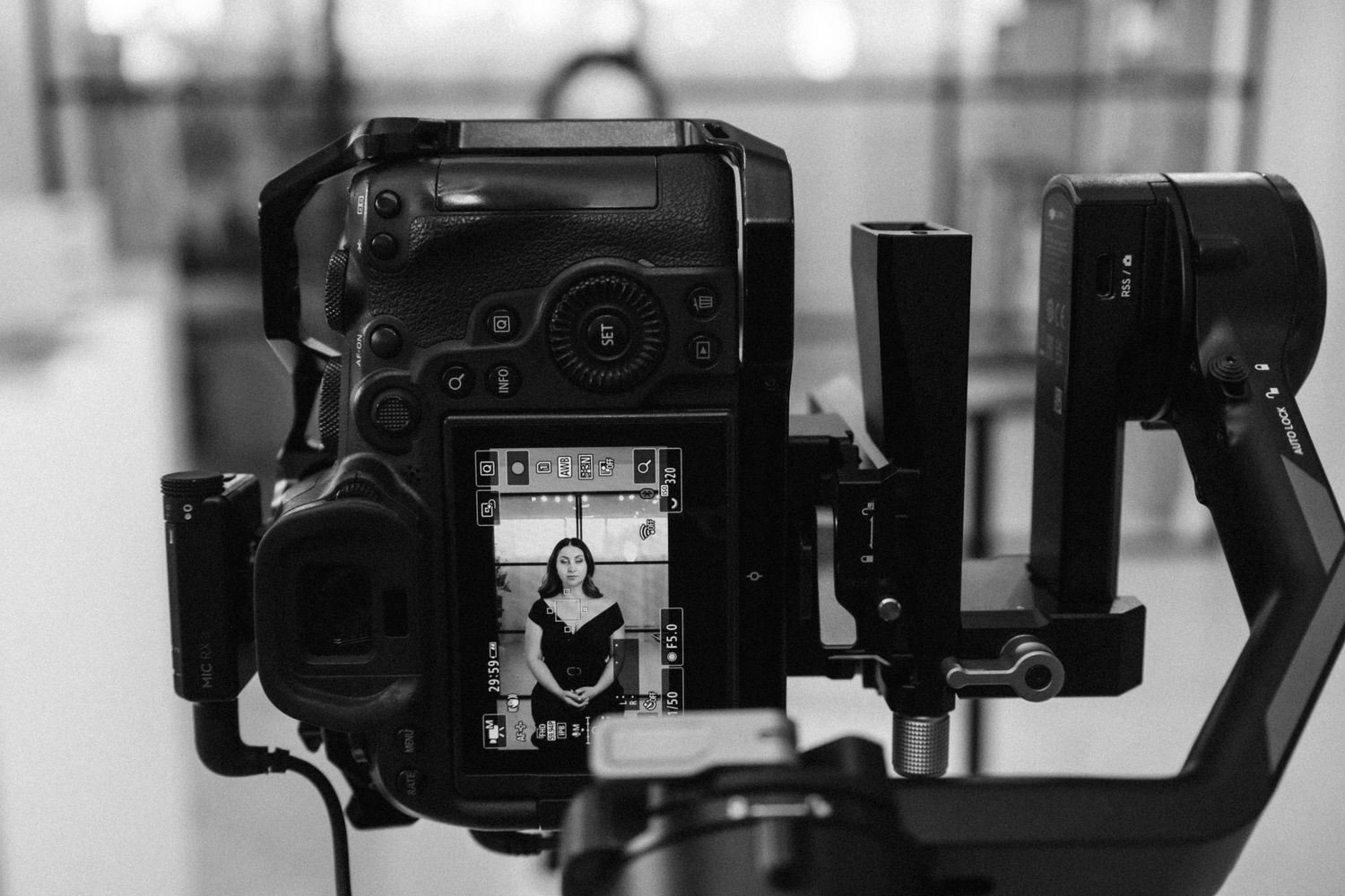 Video production setup showing multiple professional video cameras arranged in a row in a studio environment.