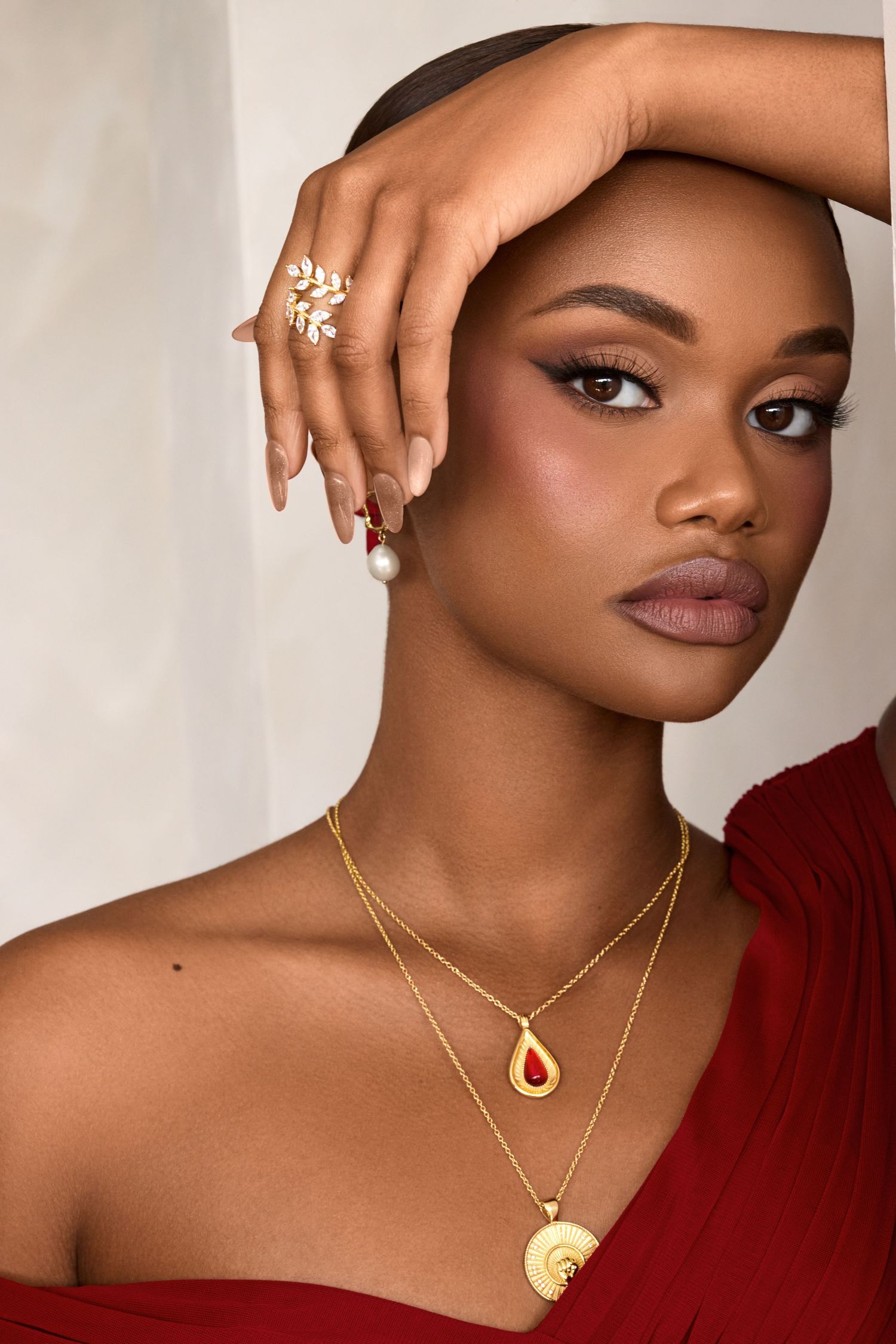 Fashion jewelry showcase with layered gold necklaces and leaf-inspired ring designs.