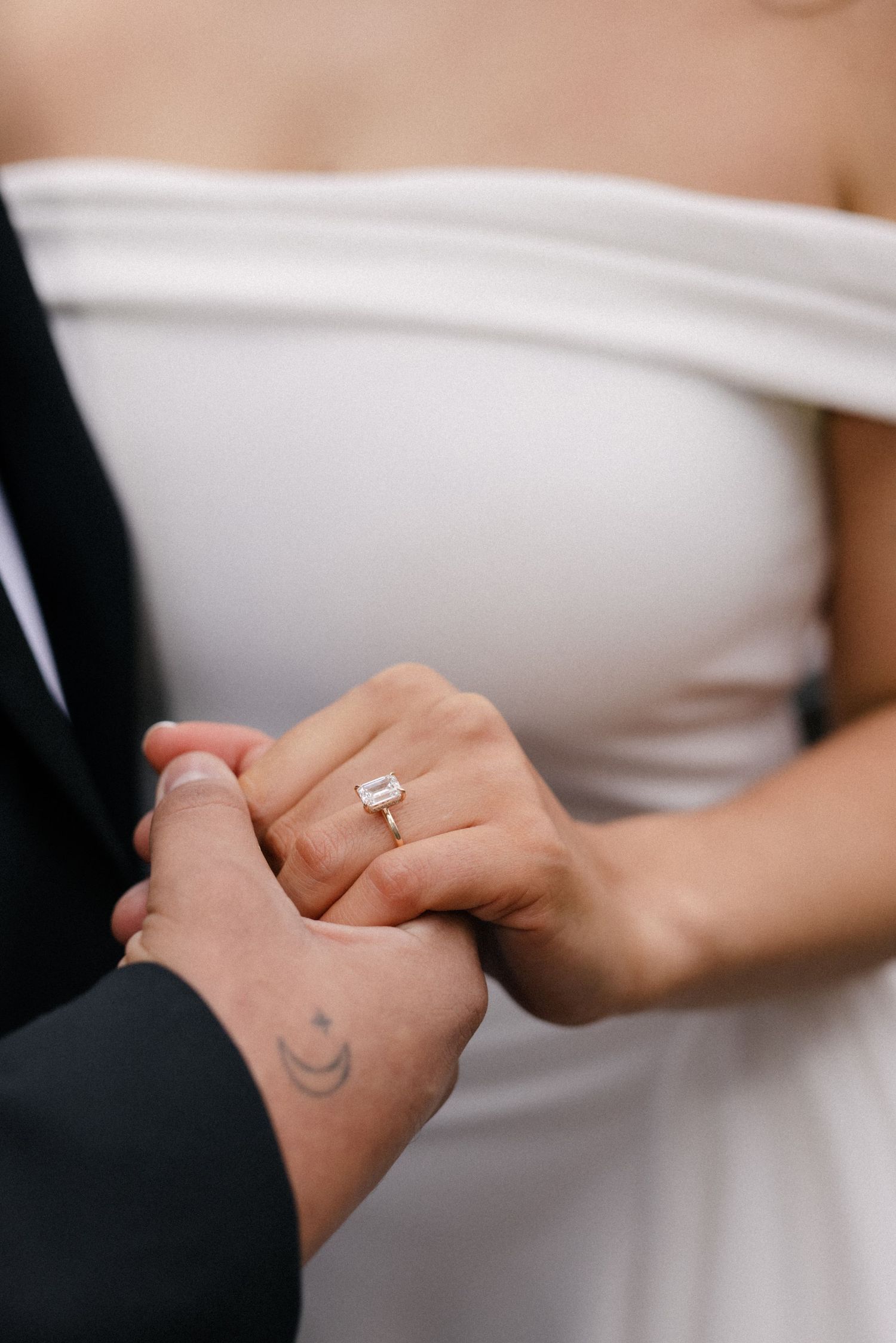 Close-up view of hands exchanging an engagement ring in a romantic moment.